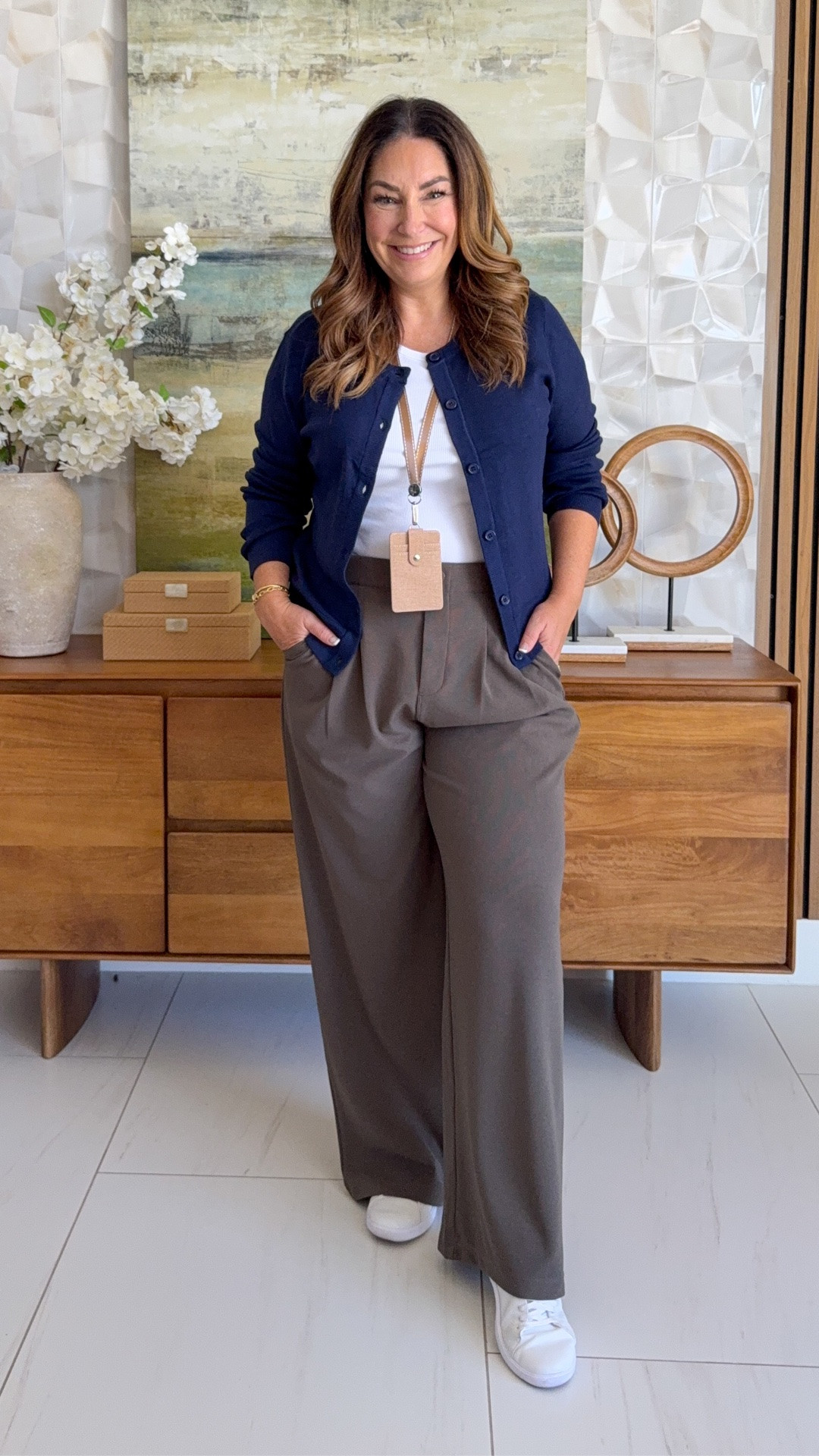 Casual teacher outfit 💙 Navy crewneck button cardigan over a white ribbed tank, tucked into olive-taupe wide-leg trousers, finished with clean white sneakers. A comfy back-to-school workwear look for days on your feet.

Sizing:  Tee tts, L // Sweater, large // pants size up if in-between wearing XL 

 #teacheroutfit #workwear #sneakers

#LTKOver40 #LTKMidsize #LTKWorkwear