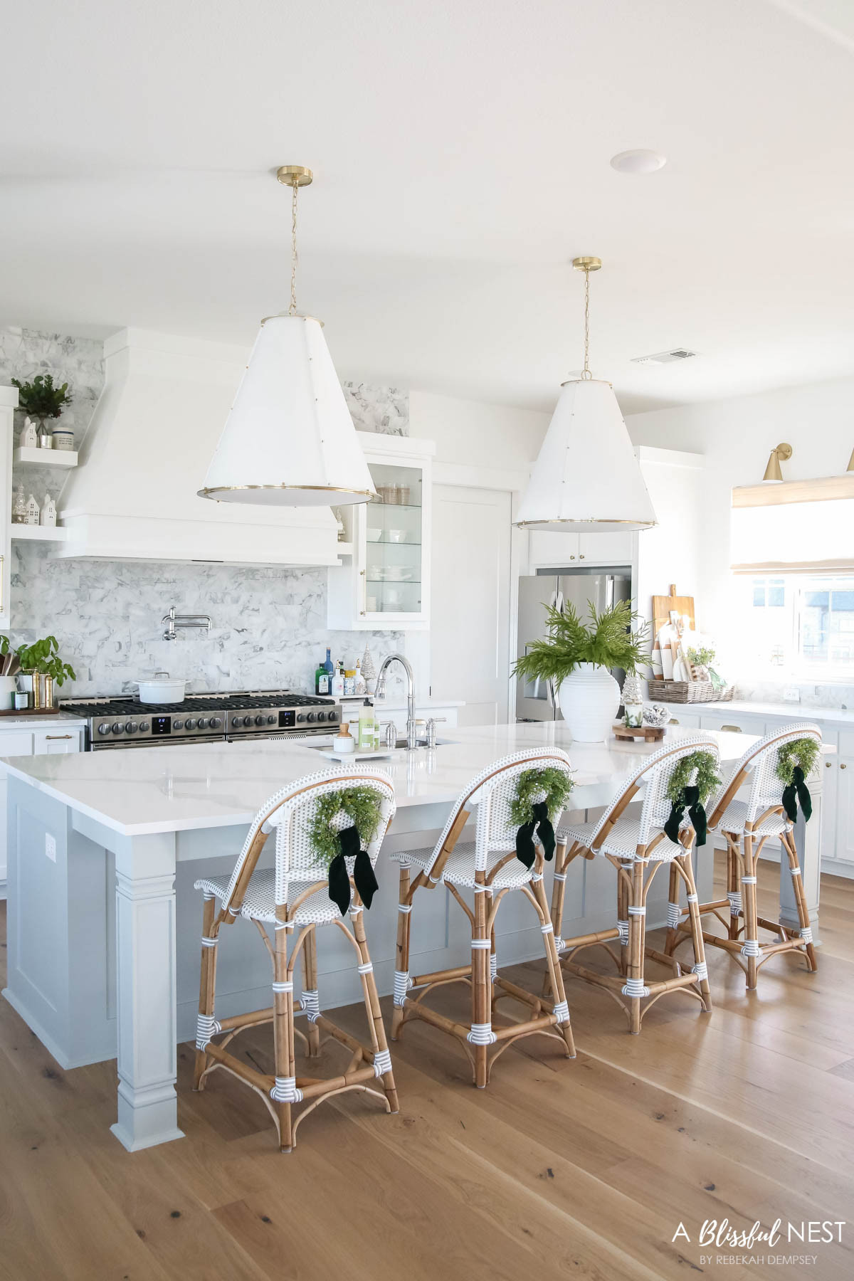 Loving how a little festive charm on the barstools brightens the whole space.
wooden spoons, bamboo dish scrub brushes, Mrs. Meyer's kitchen set, European mill, illuminated mercury Christmas trees, artificial Norfolk pine branches, suede velvet ribbon, faux juniper wreath, textured ribbed vase, Thymes Frasier Fir candle, Mud Pie utensil holder, white wood board, round wood board 

 #LTKHoliday #LTKSeasonal #LTKHome