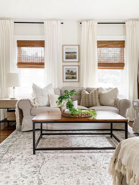 Neutral Living Room. Bamboo shades, white curtains, modern curtain rod, wood and metal coffee table, slipcover sofa, vintage art, square wood picture frames, Neutral throw pillows

#LTKFind #LTKhome #LTKstyletip