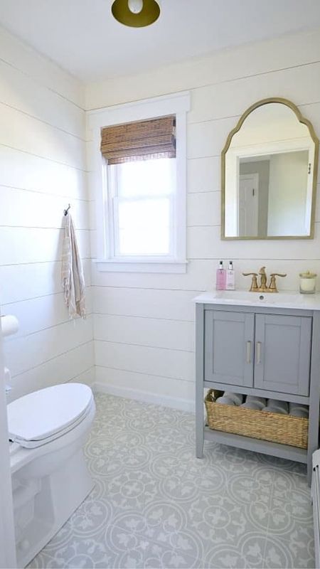 Powder room, renovation, coastal style home decor, farmhouse, decor, brass fixtures, gray cabinet, rattan window shades, gray and white patterned tile

#LTKFamily #LTKHome