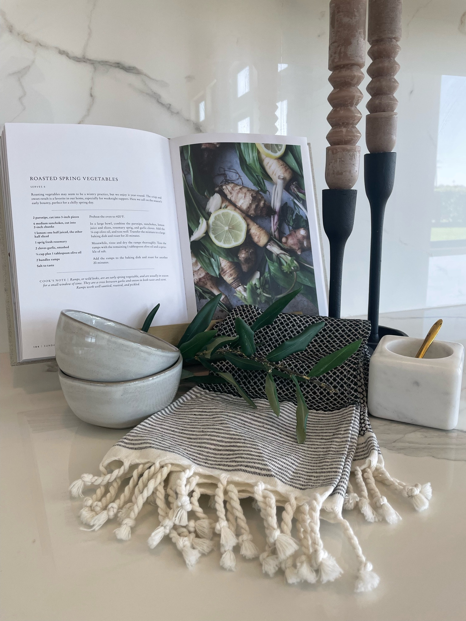 Spring kitchen styling. Kitchen design. Kitchen counter styling. Cookbook, Turkish towels, candlestick, marble, pinch pot, salt cellar, bowls. 

#kellerandoak #ltkhome #springtime #interiors #ltkseasonal 