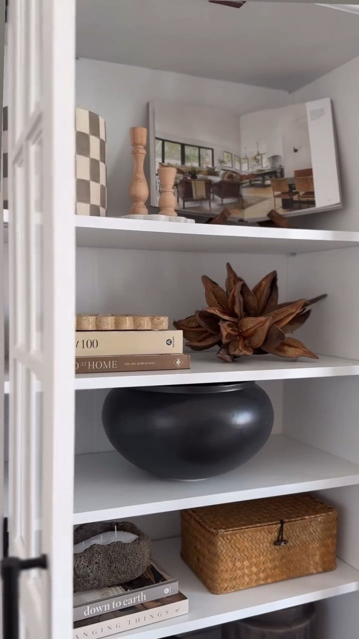 Earthy organic cabinet styling finds!
White curio cabinet, Amazon home finds, earthy home decor, bookshelf decor, checkered planter, bookstand, dried star pod, scalloped tray, wooden candlesticks 

#LTKHome #LTKFindsUnder50 #LTKSaleAlert