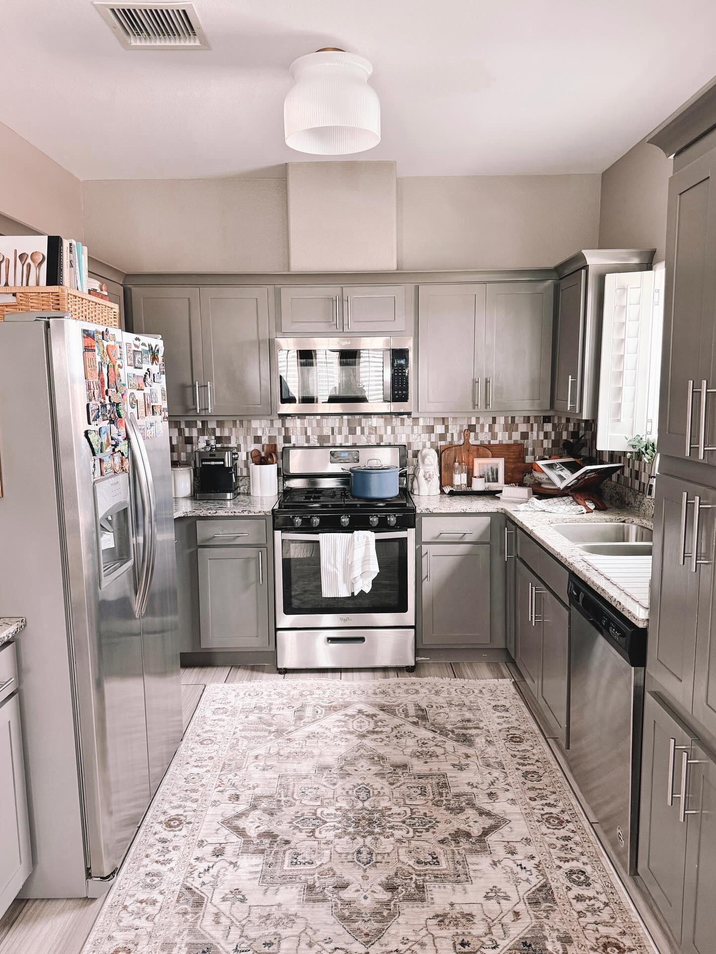 Here’s a view I never share, our kitchen. It’s small and needs new paint, our fridge is full of magnets from places we have visited instead of aesthetically pleasing ones but it is also the spot that feels most  like home. We cook 90% of our meals at home from scratch. My husband has been the chef the last few years but I’ve been his sous chef and dishwasher, lol

This gorgeous Harlow flush mount light from @hunterfanco and @jasminerothofficial has been the most convenient and beautiful upgrade. I love the vintage vibe with the milk glass look! So beautiful! 

Link in stories and bio

#hunterfans #hunterfancompany #hunterlighting #kitchen #smallkitchen #feelslikehome #homedecorating #homedecor #kitchendecor #smallkitcheninspo #neutralhomedecor #tinykitchen