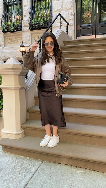 Casual spring outfit idea with a brown leather bomber, white baby tee and black satin midi skirt! 

#LTKSeasonal #LTKunder50 #LTKsalealert