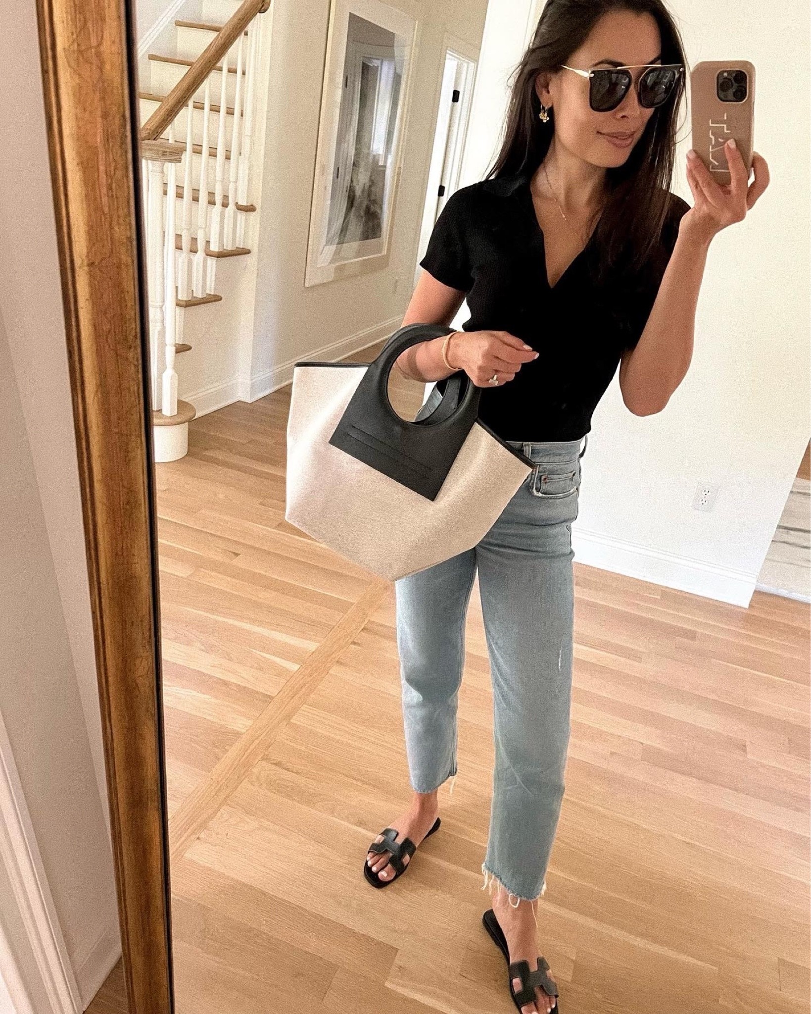 Kat Jamieson of With Love From Kat wears relaxed jeans, a polo shirt and a work tote with Hermes sandals. Everyday casual style, easy outfit, denim. 

#LTKSeasonal #LTKshoecrush #LTKitbag