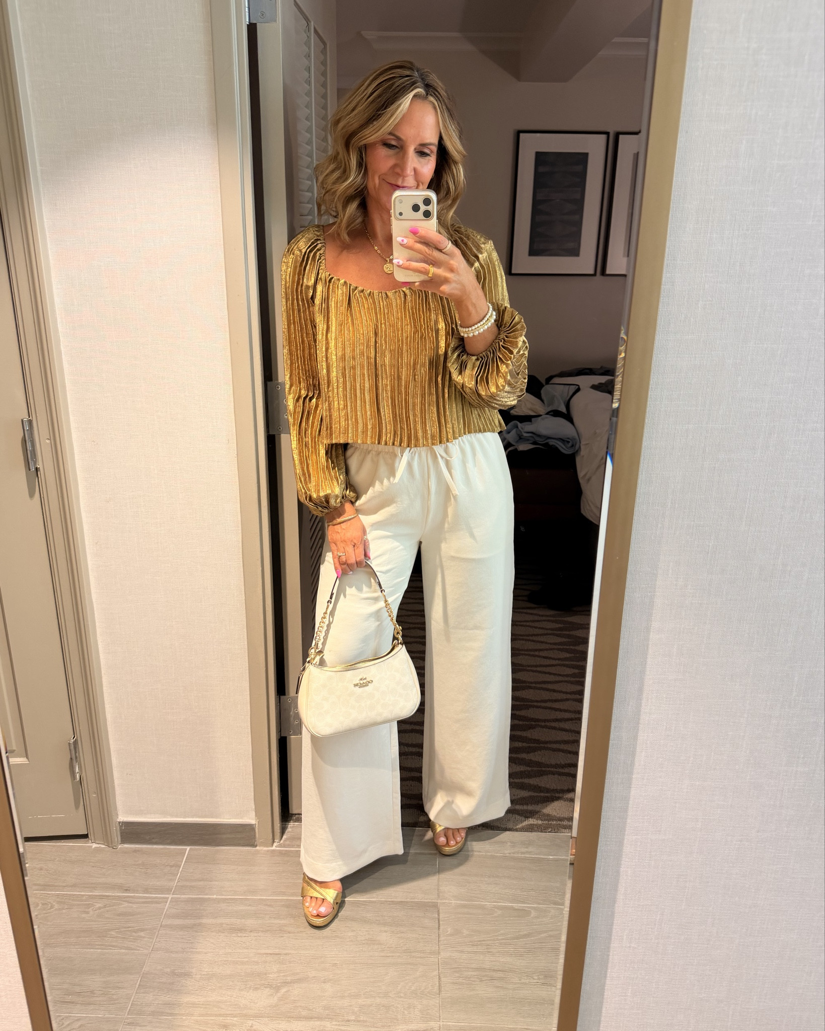 These Aritzia wide leg pants paired with this gold pleated top = elegant date night look.

#LTKootd #LTKOver40