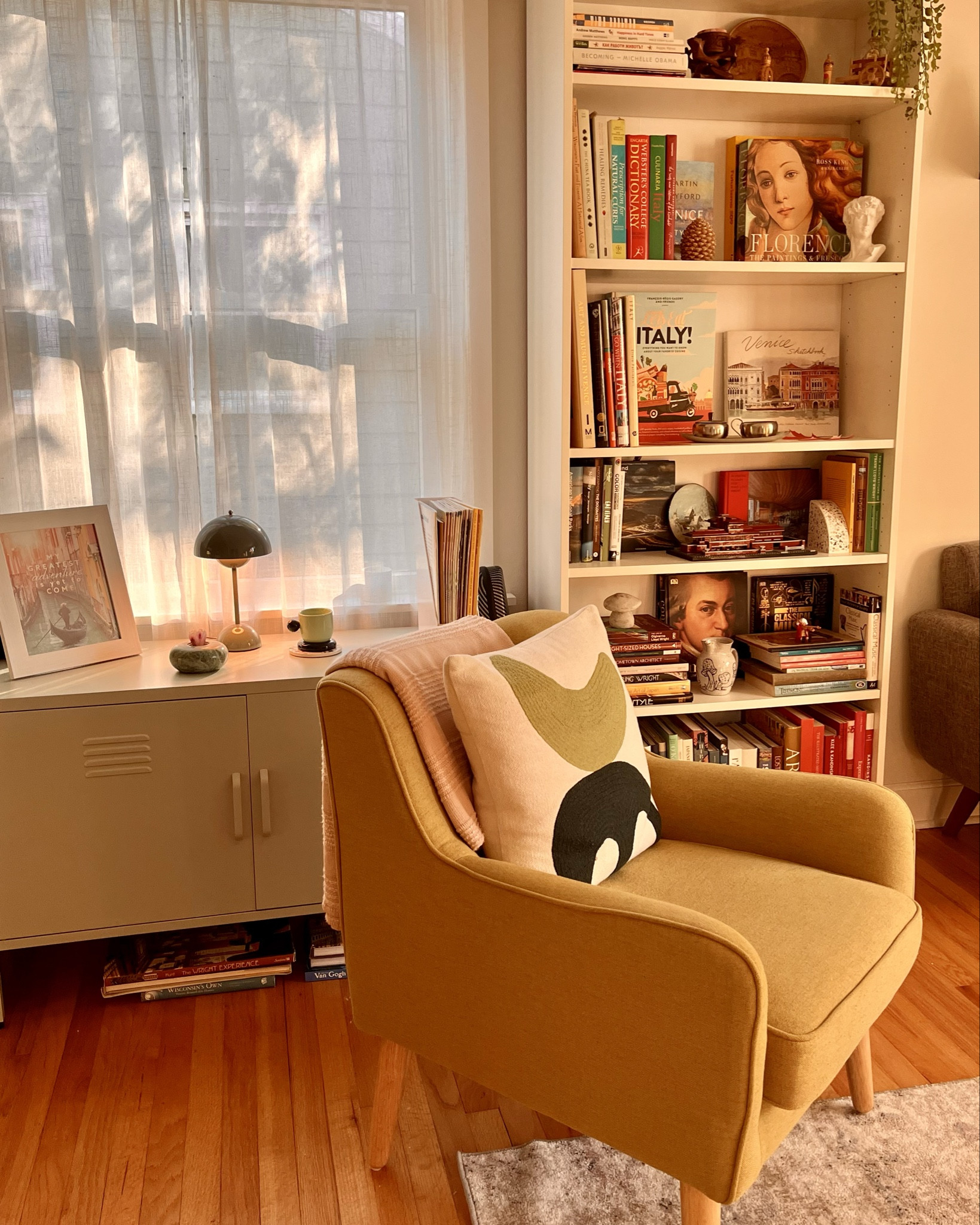 Tuesday views! I love the sage cabinet I got from Wayfair, it fits a lot! This accent chair is my favorite, still so comfy! Panton flowerpot lamp adds a Midcentury flair! The rug is gorgeous—affordable and washable! 

#LTKStyleTip #LTKHome #LTKSeasonal