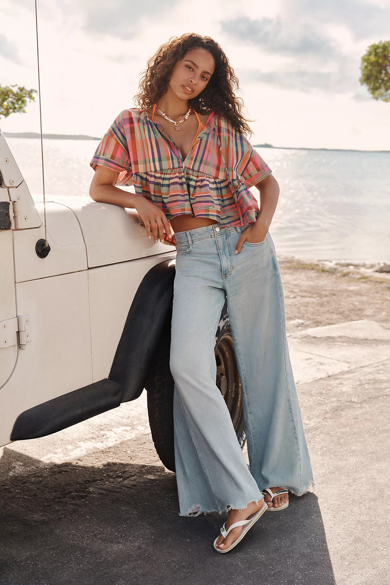 The Adi Regenerative Cotton Mid-Rise Frayed Relaxed Flare Jeans by Pilcro | Anthropologie (US)