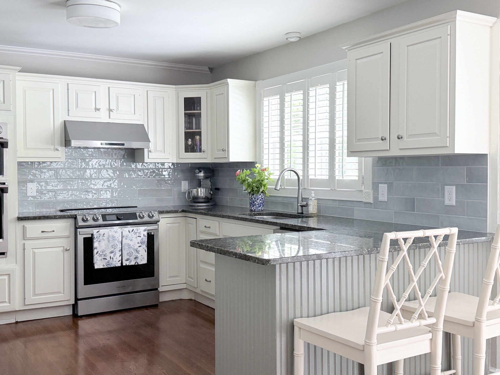 Kitchen refresh with blue / gray tiles, gray grout, cream cabinets, whitemikk glass lighting, and cream cabinets with bamboo counter stools.

#LTKHome