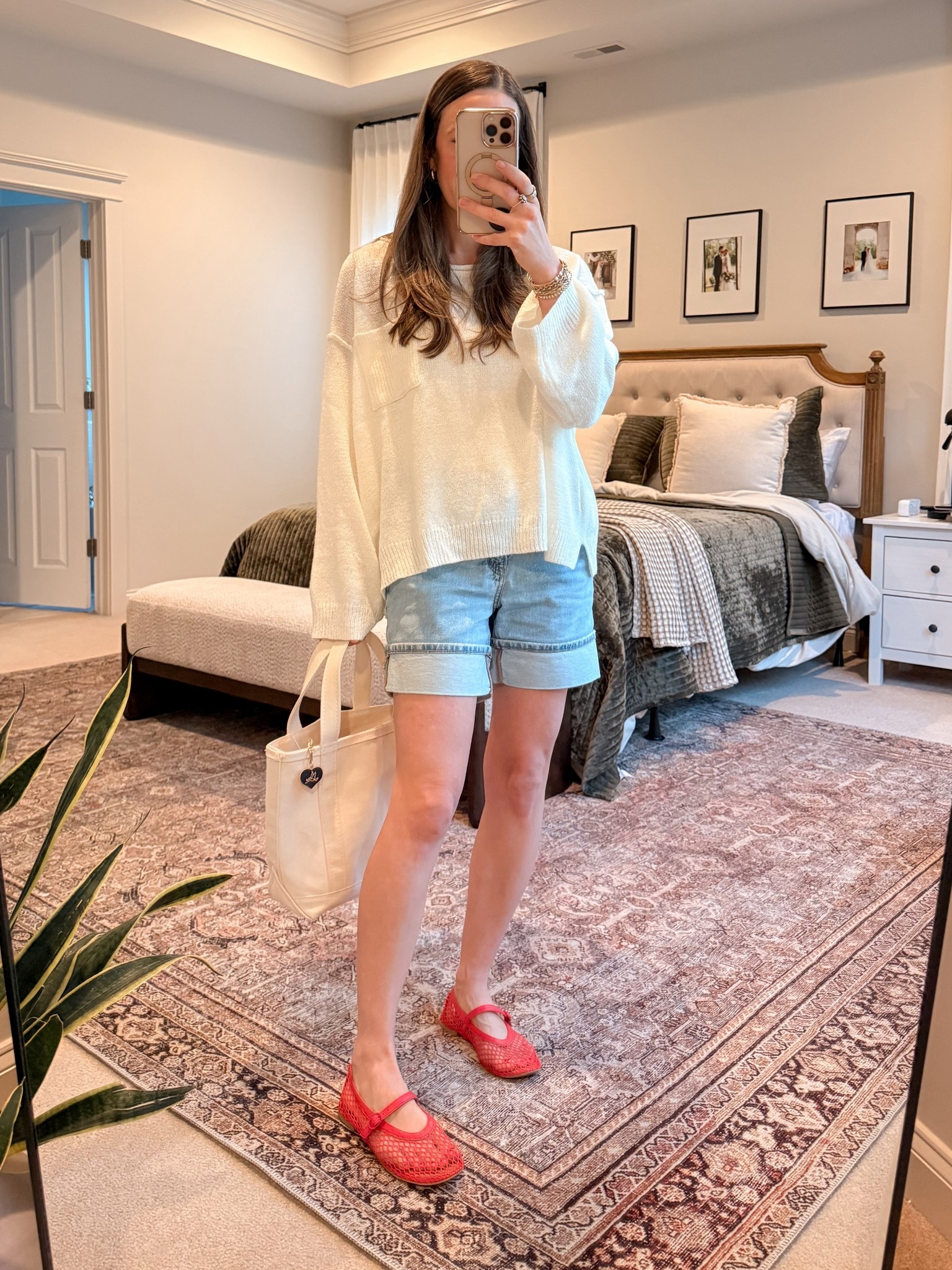 Casual Spring Mom Outfit ❤️

• Lightweight neutral sweater
• Cuffed denim shorts
• Red Mary Jane flats
• Neutral canvas tote

This is my favorite kind of transitional outfit — cozy on top, easy on the bottom, and a bold shoe to make it feel styled.

The oversized knit keeps it relaxed and comfortable, the cuffed denim shorts balance the proportions, and the red flats instantly elevate the entire look.

Perfect for:
• Casual mom outfits
• Spring shorts outfit
• Denim shorts styling
• Red flats outfit ideas
• School drop-off outfit
• Elevated everyday basics
• Capsule wardrobe summer

This is one of those simple outfit formulas you can repeat all season: neutral base + classic denim + one statement accessory.

#LTKSeasonal #LTKgrwm #LTKmomlife