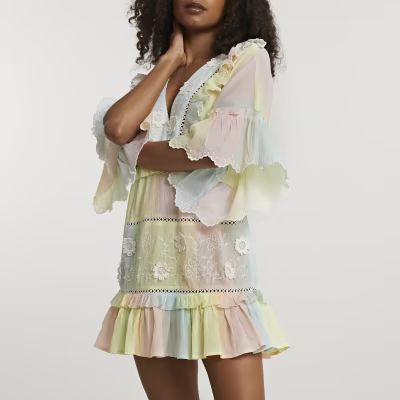 Yellow ruffle tie dye mini beach dress | River Island (US)