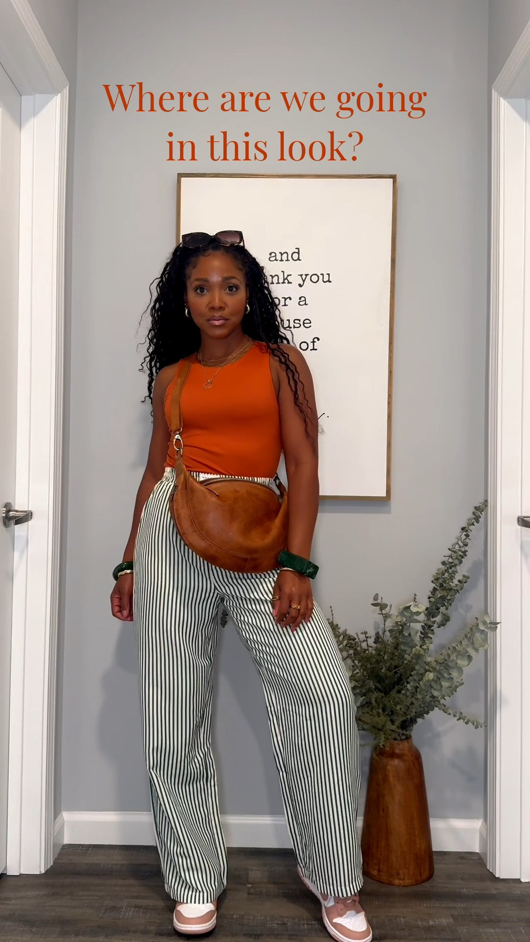 Where to wear:
Vacation, outdoor dinner, brunch, sightseeing, art festival, travel day.

This might be one of my favorite summer outfits 🧡 The orange tank adds the perfect pop while the striped pants keep everything relaxed and effortless.

Sizing
* Tank: Small
* Pants: Medium
* Sneakers: True to size