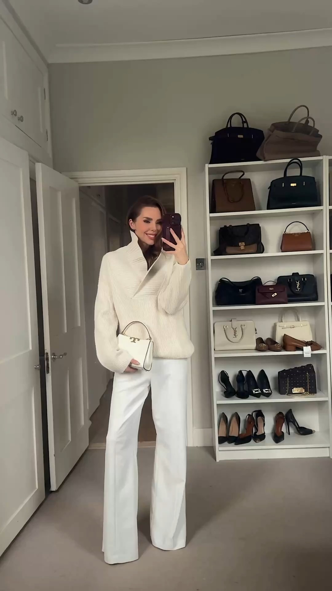 Winter Whites
Cream oversized knit with a deep funnel neckline paired with tailored white trousers. Styled with a structured ivory mini bag and soft glam makeup for a polished, tonal look.