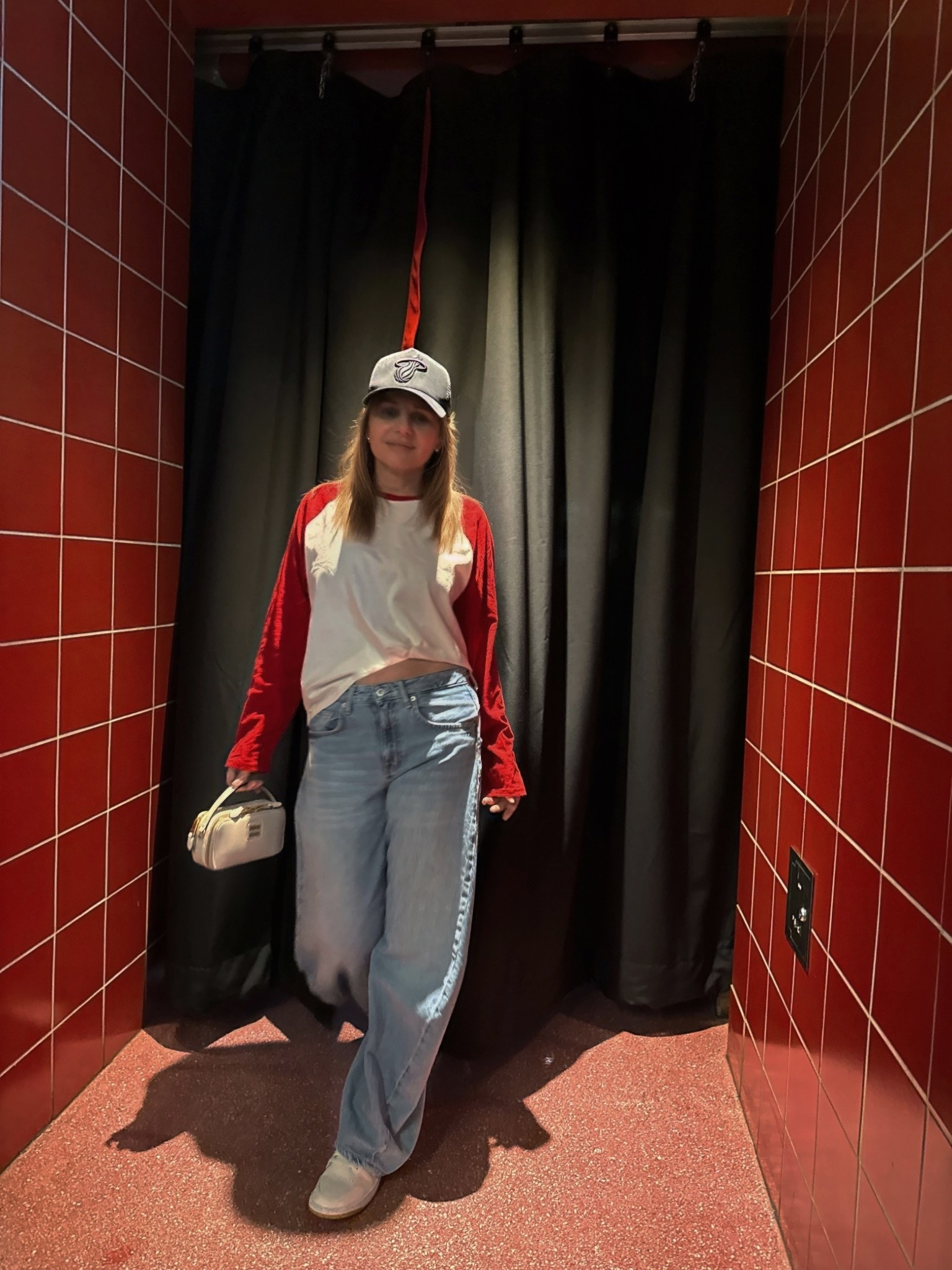 Last Heat home game of the season 😢 but snapped this pic of my outfit. Wearing a 3/4 sleeve red and white raglan baseball jersey shirt w loose fit low rise light wash jeans, black Miami Heat hat and my white on white Jordans. 

#LTKSeasonal #LTKSaleAlert #LTKootd