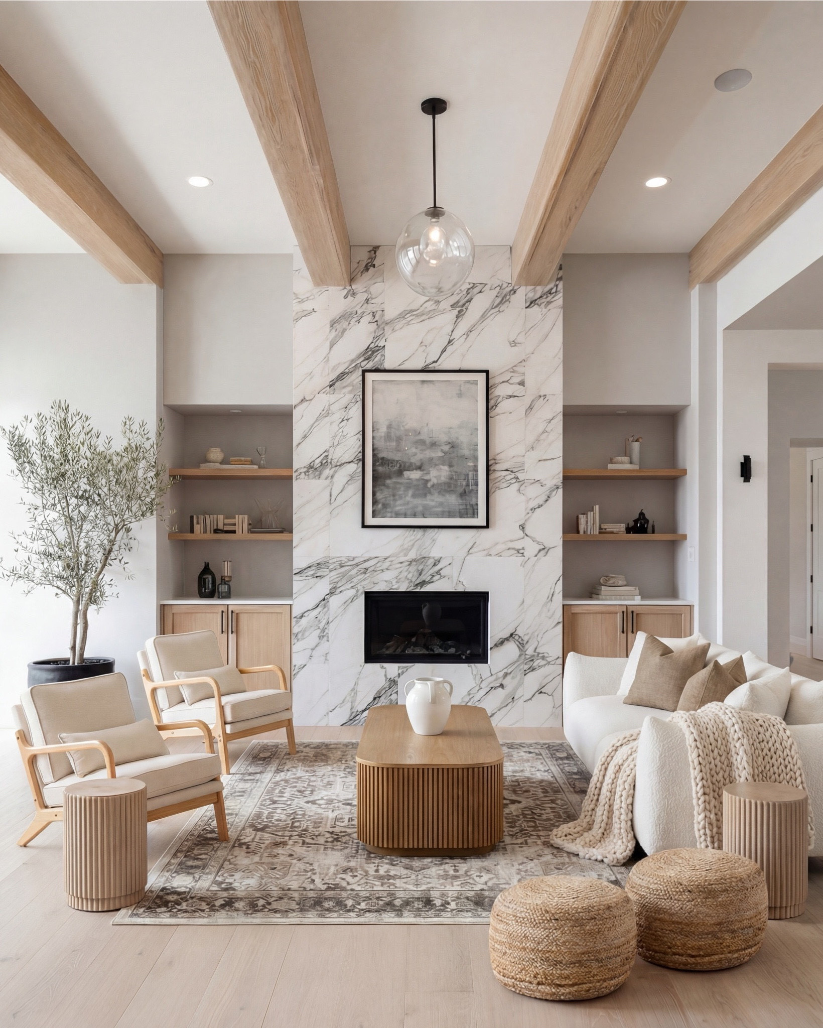 Soft, sculptural, and effortlessly serene — this living room blends creamy textures, warm woods, and a marble statement fireplace to create a calming, elevated retreat. The veined stone surround becomes the focal point, while the fluted coffee table and side tables bring subtle architectural interest. Layered neutrals in the sofa, knit throw, and accent pillows soften the space, and natural woven elements add warmth without overwhelming the palette. This is modern minimalism with soul — light, welcoming, and thoughtfully composed.

Shop the Look:
• Fluted light-oak coffee table
• Cream textured curved sofa
• Chunky knit throw in warm beige
• Neutral linen accent pillows
• Light-wood armchairs with cream cushions
• Marble fireplace surround panel
• Round glass pendant light
• Woven natural pouf stools
• Fluted wood side tables
• Vintage-inspired neutral area rug
• Potted faux olive tree

#LTKsale #LTKhome #LTKstyletip