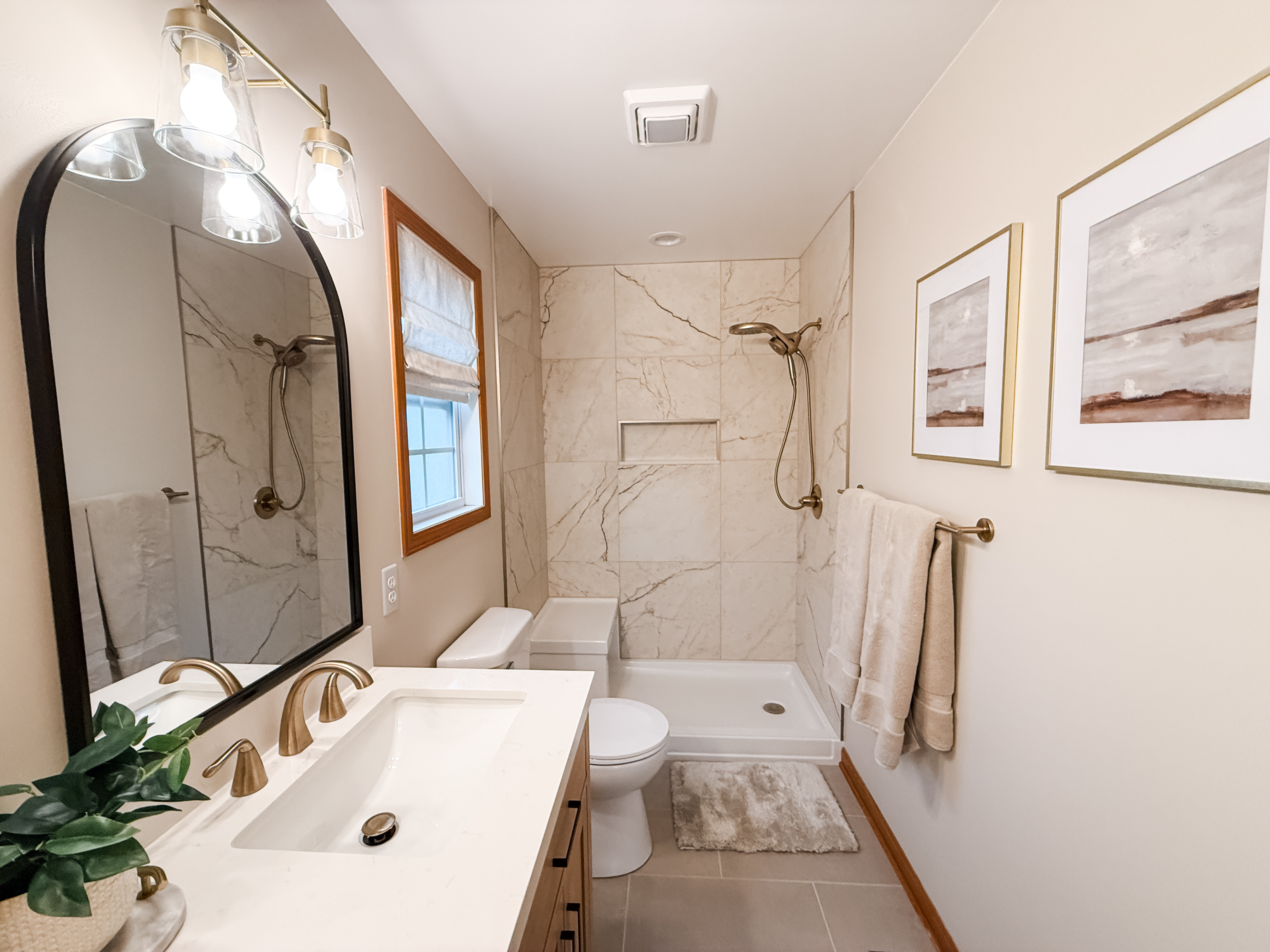 PROJECT REVEAL- A Primary Bath Renovation that gave a luxe look and incorporated a few budget friendly finds.   

We mixed a black matte arched mirror with champagne bronze plumbing fixtures to compliment both warm and cool tones. Neutral rugs bring out some of the veining in the tile and Etsy prints inside our favorite Target frames add even more character to the space.  

 #LTKHome #LTKStyleTip