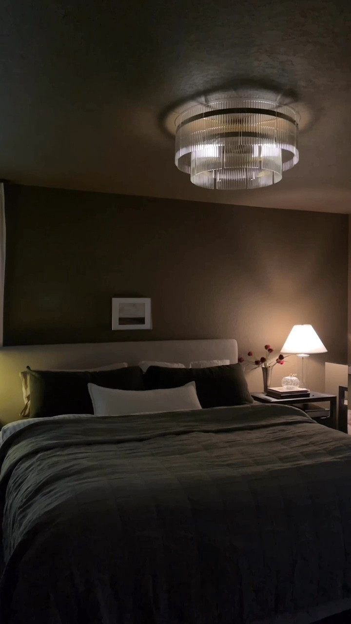 #ad I finally changed the light I’ve been side-eyeing for months thanks to @loweshomeimprovement 

It started as a basic can light and just never matched the room, but now it feels like a luxury hotel suite every time I walk in… a soft glow, the beautiful ribbed glass, the whole thing is such a vibe. But let’s be honest, any glass looks absolutely beautiful against these dark brown painted walls. 

What do you think? Did I make the right decision by swapping out this fixture?

Shop this light + a few of my favorites here: https://shoplowes.me/4ny4nR7

#earncommission #lowesfinds #lowespartner #moodyinteriors #buildergradeupgrade #bedroominspo 