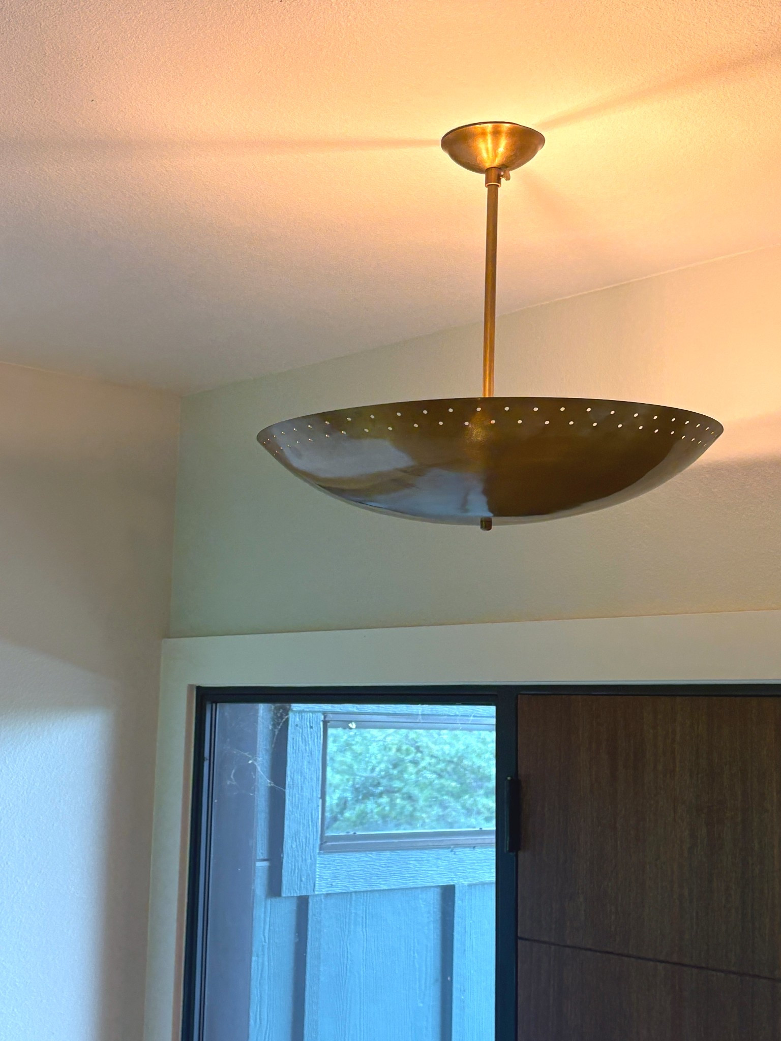 New entryway light! It’s a mid-century style raw brass sputnik saucer perforated I don’t even know what to really call it pendant light. The brass is absolutely beautiful, and it’s not vintage, but certainly feels like it.

#brass #pendantlight #mcm #lighting #midcentury #brasslighting 

#LTKHome