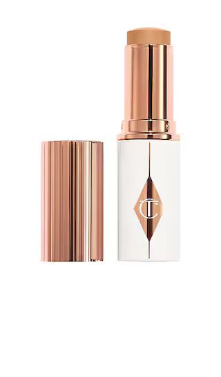 Charlotte Tilbury Unreal Skin Sheer Glow Tint Hydrating Foundation Stick in 9 Tan. | Revolve Clothing (Global)