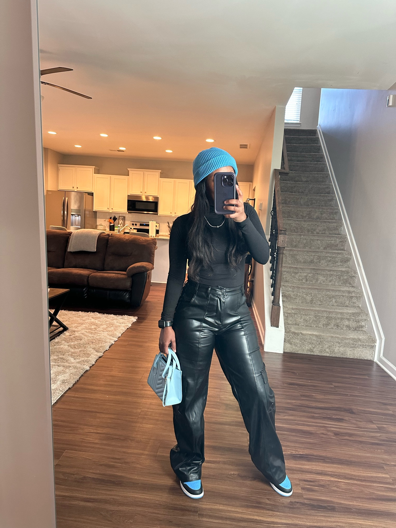 How to style black wide leg cargo faux leather pants with a black bodysuit, blue beanie, blue purse, and Jordan 1 UNC tie sneakers

#LTKSeasonal #LTKStyleTip #LTKShoeCrush