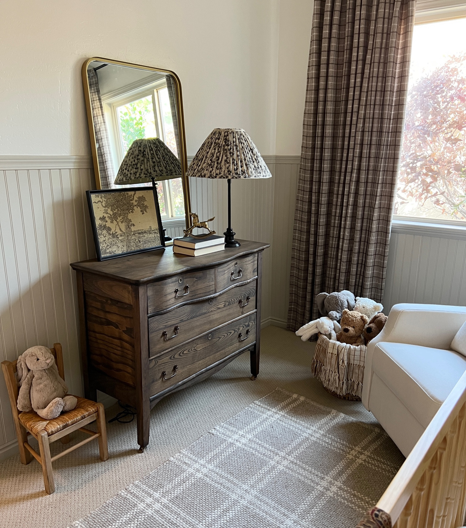 Neutral nursery styling 

Neutral spindle crib light natural wood upholstered glider white fabric check plaid throw pillow cover dark beige kilim stripe tan ivory pillow cover brown kantha quilt vintage framed art landscape vintage city brown rug Jellycat stuffed bunny doggy plaid drapery curtains vintage aged brass rocking horse arched mirror vintage childs chair iron floor lamp small faux tree pleated lamp shade floral black fabric kids woven rush seat chair vintage brass horse 

#LTKstyletip #LTKFind #LTKunder100