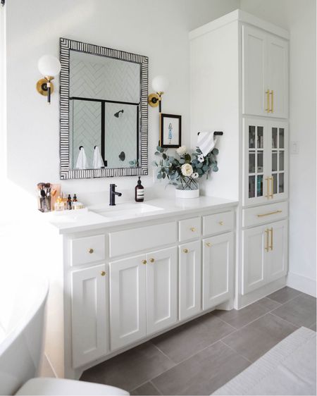 Our primary bathroom with bone inlay mirror from Serena & Lily, sconces, dipped vase, bath runner, bath mat, brass hardware, brass cabinet pulls and faux florals. Love how this turned out and it looks modern, fresh and high end

#LTKHome #LTKStyleTip