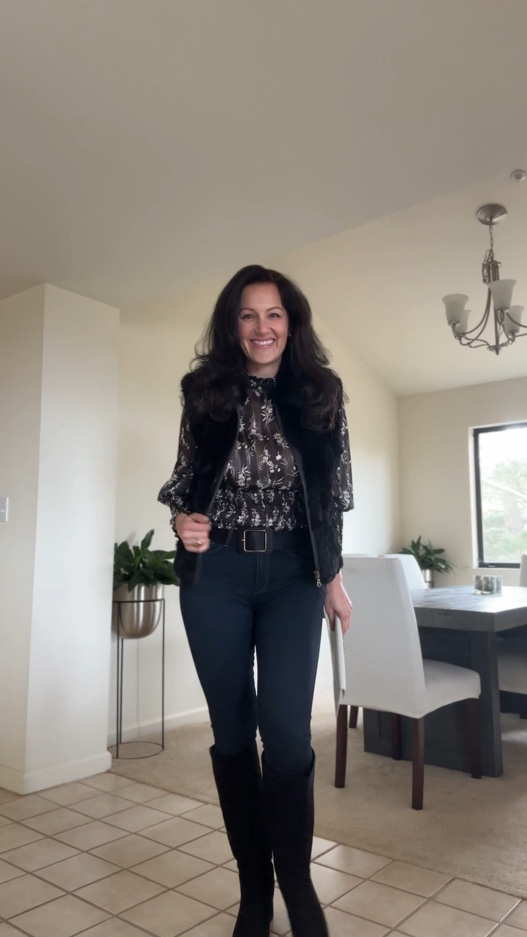 Chic winter casual outfit featuring skinny jeans, knee-high boots, a faux-fur vest, and an elegant blouse styled with designer sunglasses and a clutch bag. A sophisticated cold-weather look for daytime outings, travel, or polished everyday style. 

#LTKSeasonal #LTKdayinmylife #LTKootd