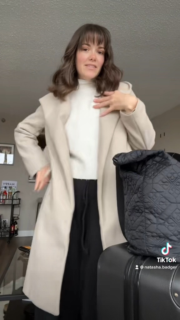 Go-To Stylish Travel Outfit🥰 Wearing wide leg black sweatpants, white sweater, beige wrap coat, and new balance sneakers  

#LTKtravel #LTKeurope