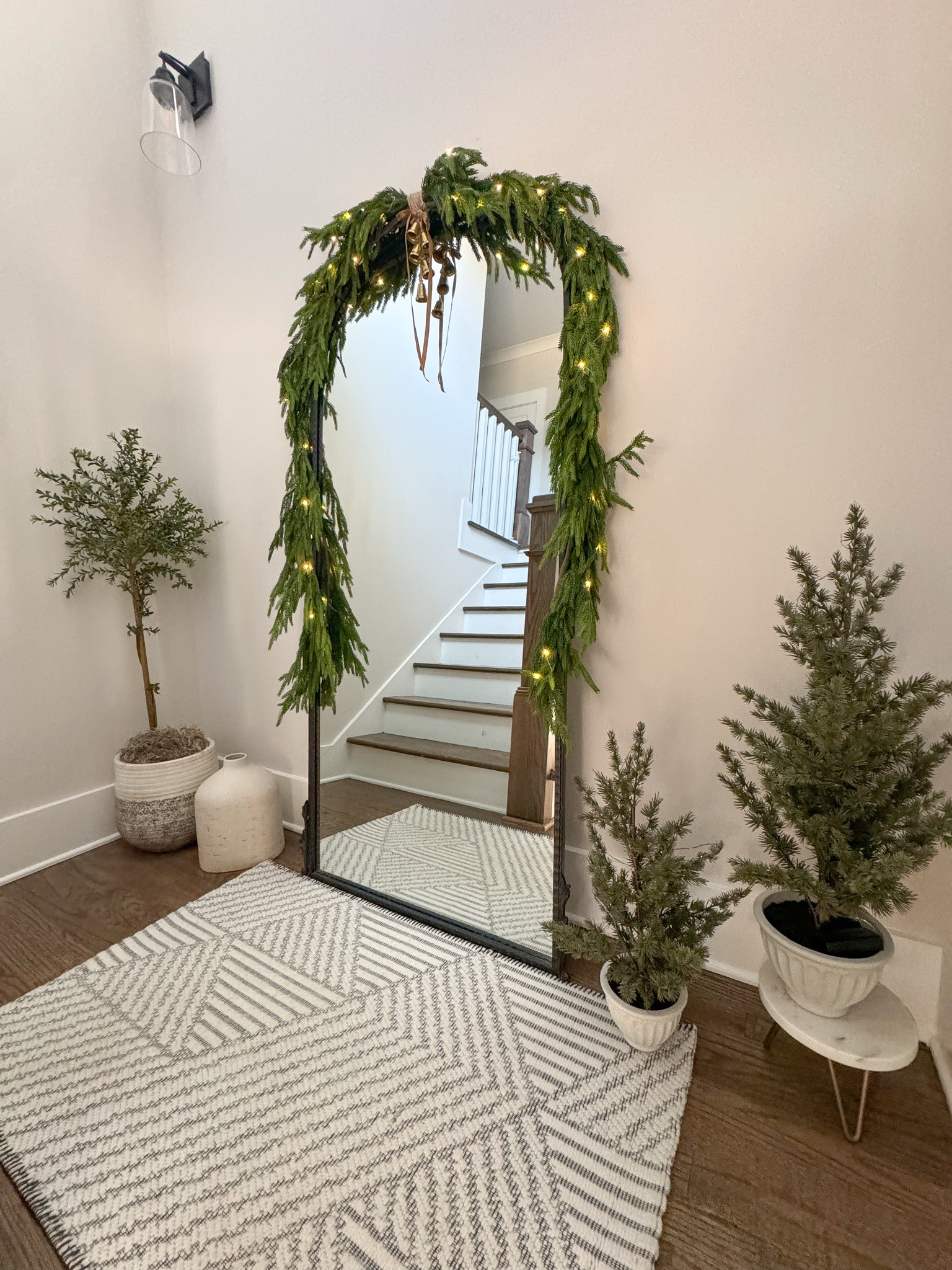 ✨Decorating my stairwell for Christmas 🎄 

Comment “shop” below for links 🔗 

I made a DIY garland swag for my floor mirror by attaching two (6ft) Norfolk Pine Garland with twine. I then added these adorable small bells, a velvet bow and fairy lights. 

#christmasdecor #garland #holidaydecorating #christmasstairs #mirrorswag #homedecor #interiordesign

#LTKHome #LTKSeasonal #LTKHoliday