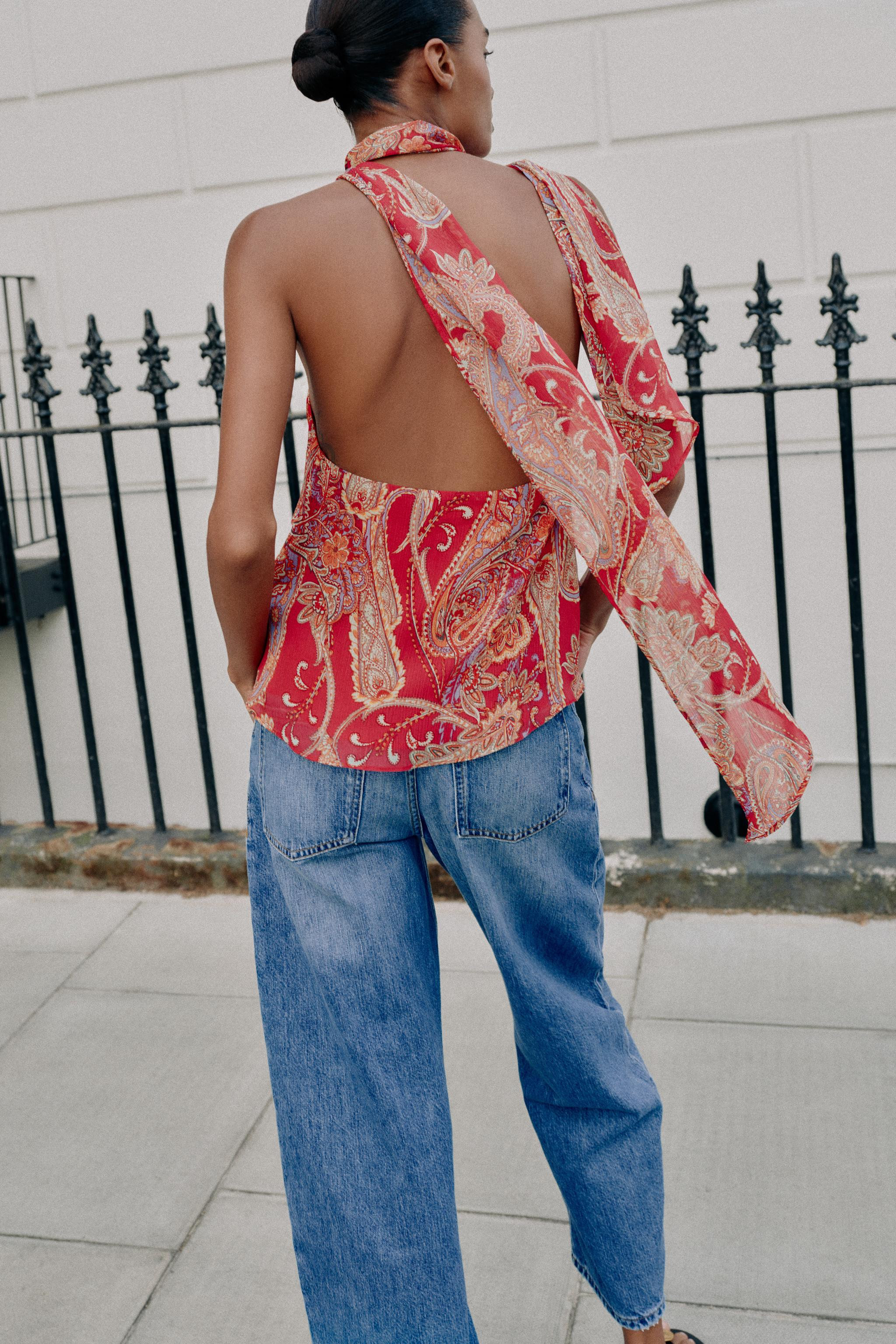 Halter neck top featuring a tie detail and open back. Front ruffle details. Lined. Back hidden bu... | Zara US