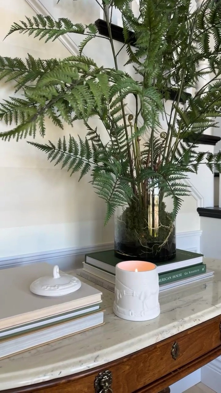 Simply styled entryway: books, candles, fern all linked! 

#LTKHome