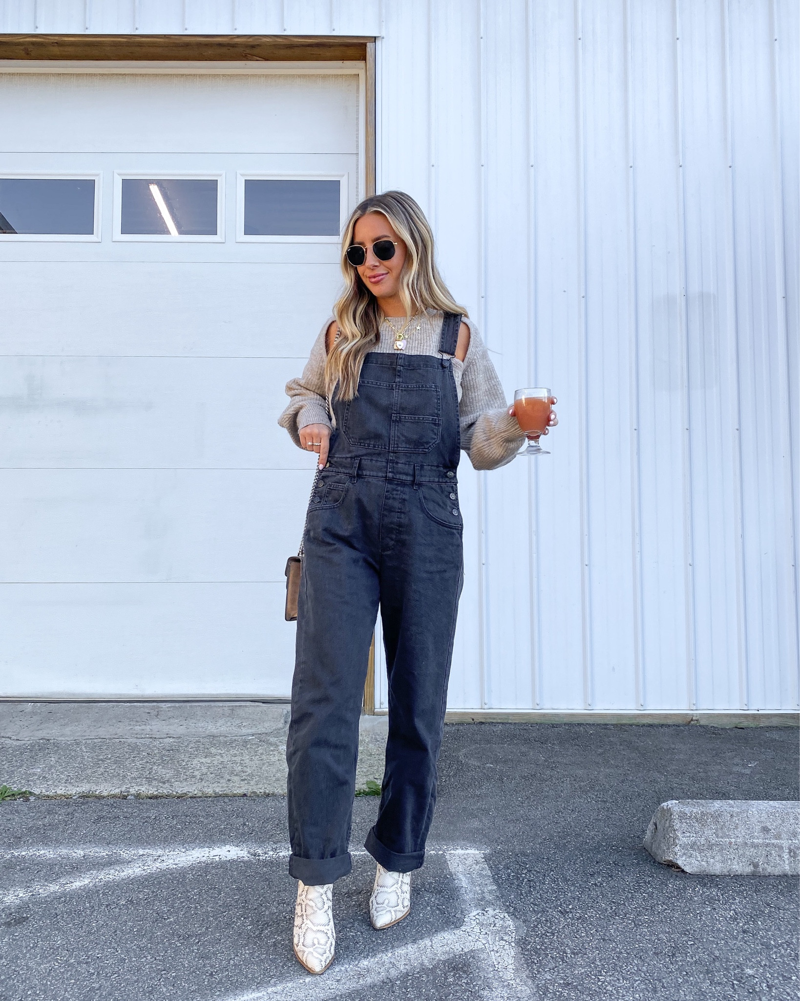 Cutout sweater and black free people overalls, wearing medium in the sweater and small in the overalls but wish I had done small in the sweater and xs in overalls! Go with tts for sweater and consider sizing down for overalls, especially if short/petite!