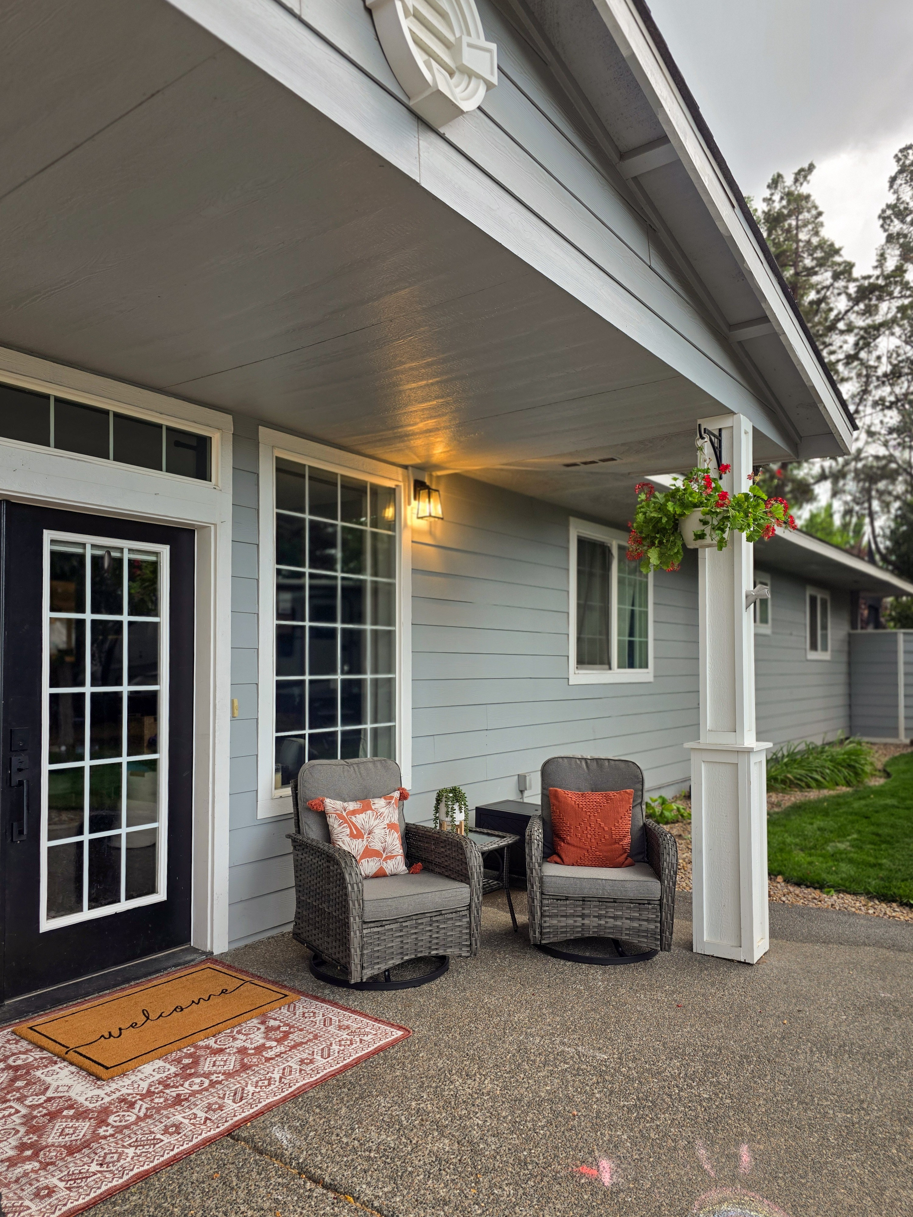 This porch is proof a few swivel chairs and the right pillows can turn a front entry into an actual hangout spot. We layered in a durable outdoor rug and doormat so it stays cozy no matter what the Oregon weather throws at it. #porchdecor #outdoorliving 

 #LTKSeasonal #LTKHome