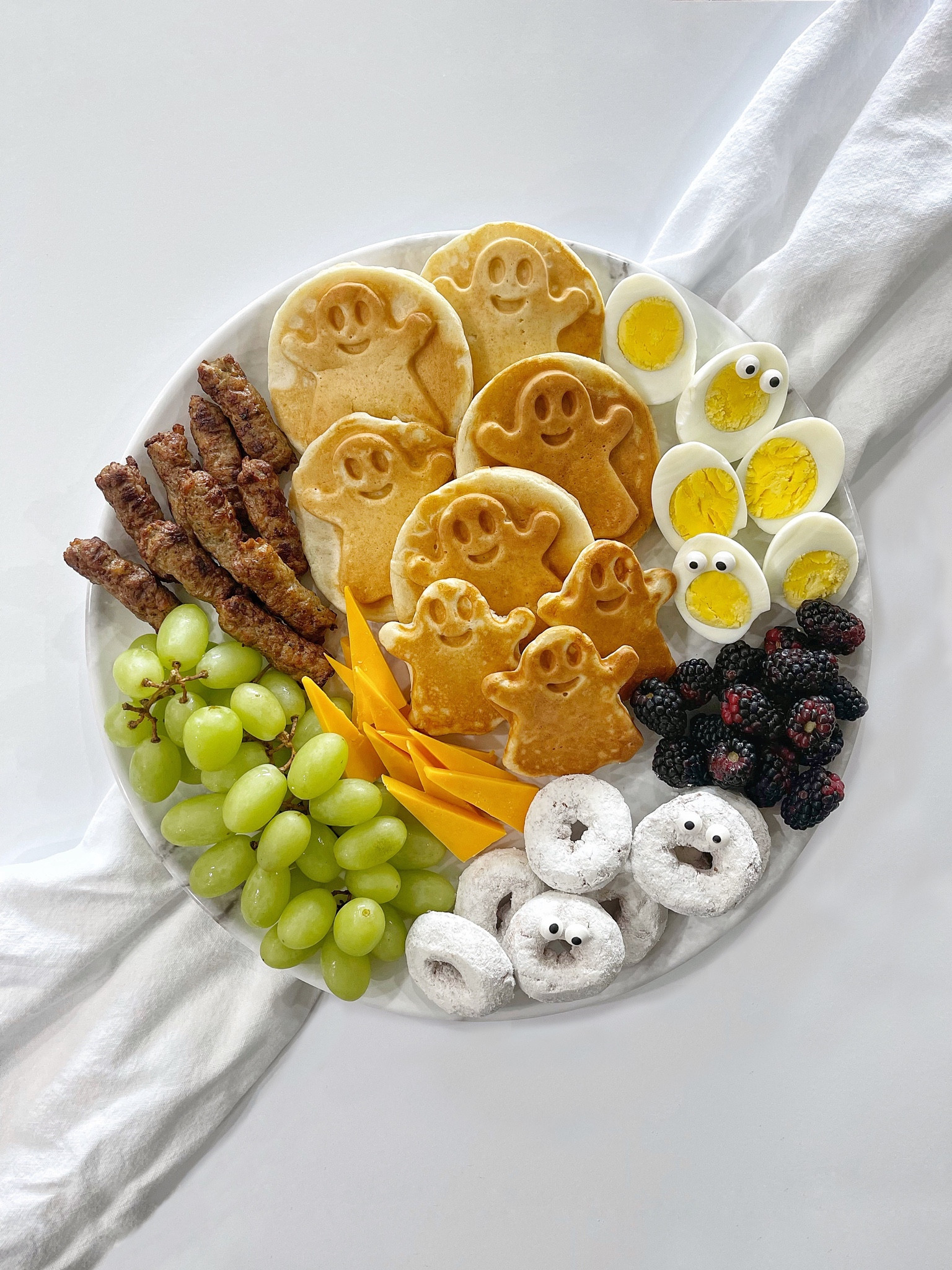•SPOOKY GHOST BREAKFAST BOARD• 👻🧇

WHAT’S ON THE BOARD: 
mini ghost waffles- used @birchbenders 
@egglandsbest hard boiled eggs
@driscollsberry organic blackberries
@entenmanns mini powdered donuts
@publix Greenwise green grapes
@cabotcreamery extra sharp cheddar
@jonesdairyfarm chicken sausage 
Edible candy eyes 

#LTKSeasonal #LTKparties #LTKkids