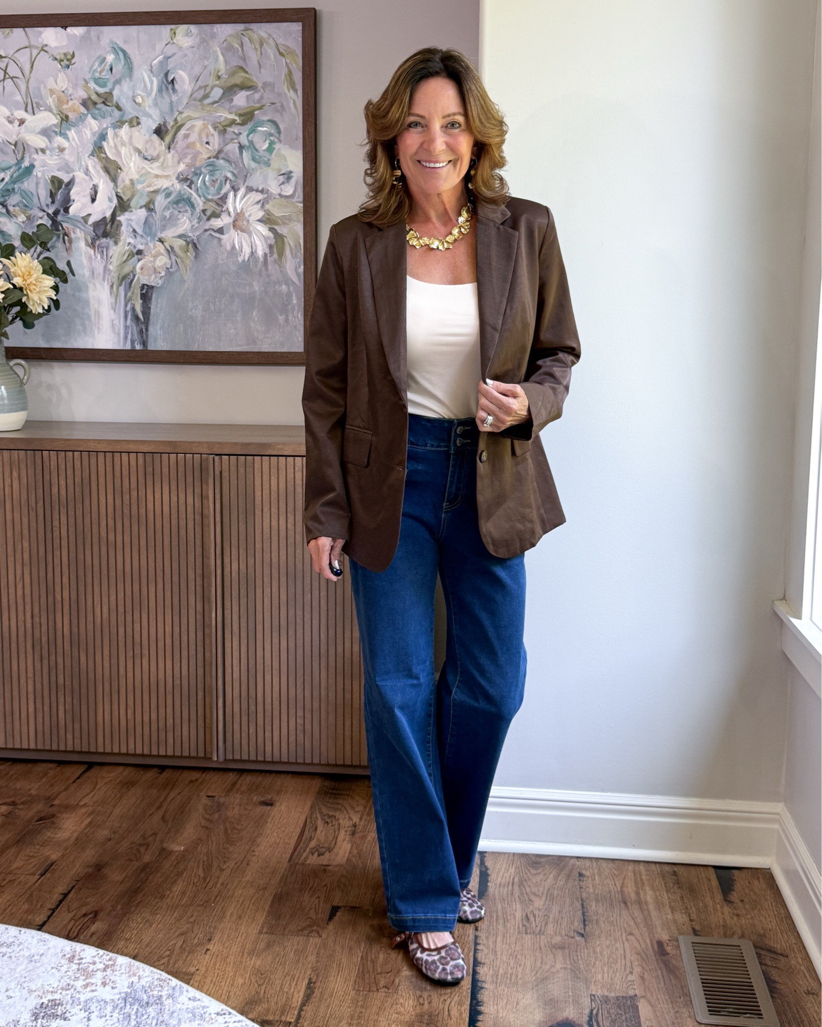 How to Dress Up Jeans for Fall

A chocolate brown blazer instantly makes wide-leg jeans feel more polished without making the outfit too dressy. I kept the base simple with a cream tank, then added gold jewelry and leopard flats for a little personality. An easy formula for dinners, meetings or anytime jeans need an upgrade.

#over50style #falloutfit #blazerstyle #jeansoutfit #casualchic