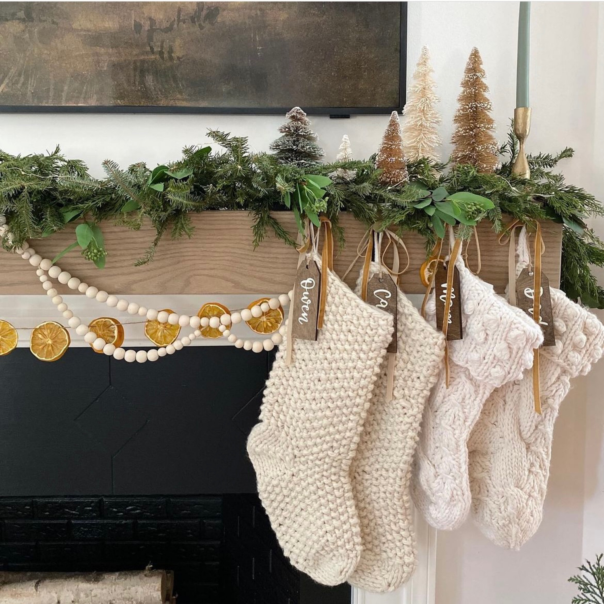 Merry mantle decor! Neutral Christmas decorations. Garland, cable knit stockings, bottlebrush trees, and dried orange slices. Perfect for a neutral living room aesthetic. 

#LTKSeasonal #LTKfamily #LTKHoliday