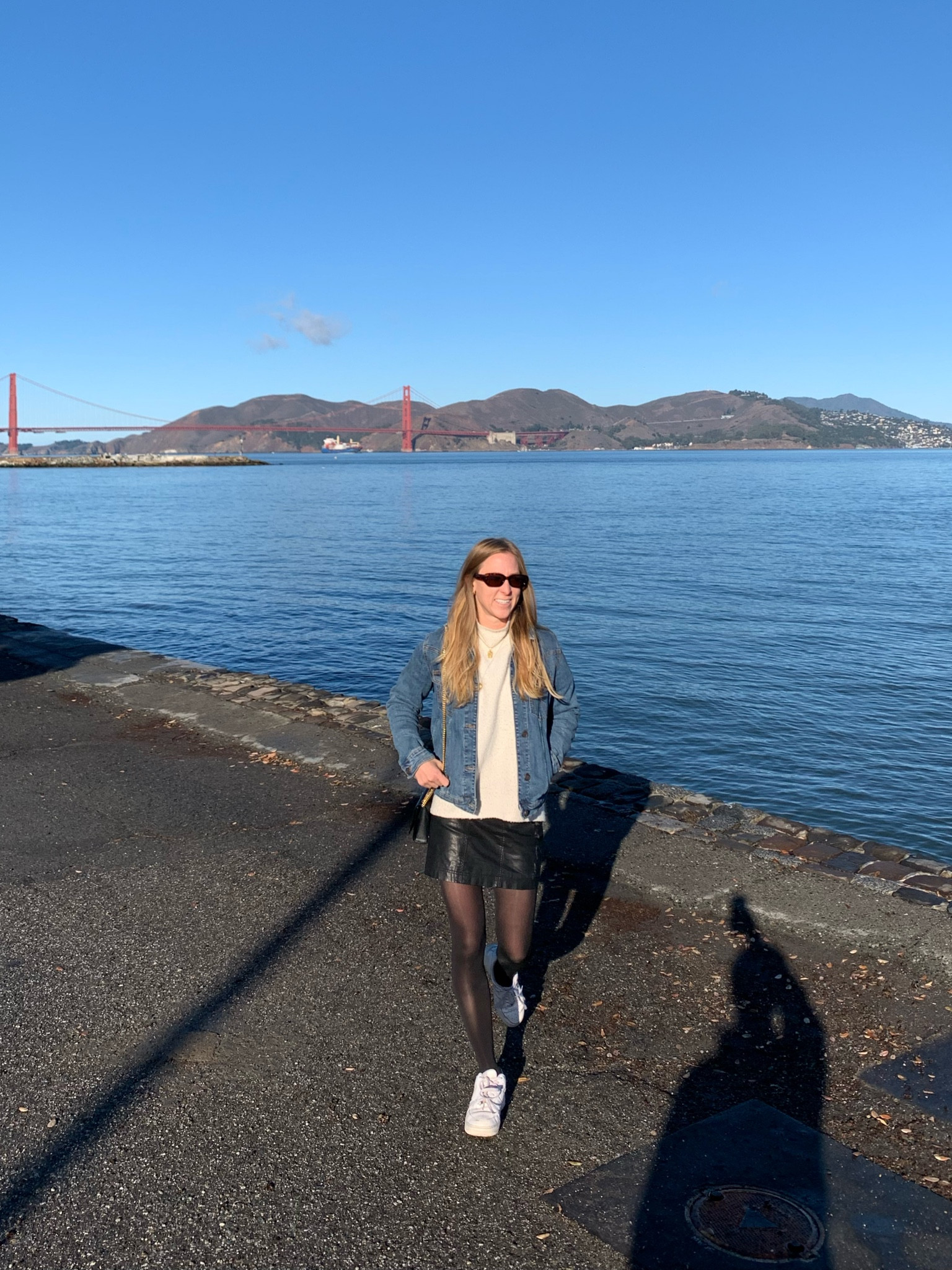 Black leather vegan mini skirt, oversized white turtleneck sweater, trendy tortoise sunglasses, white nike Air Force 1 sneakers, black sheer tights, ysl black bag in San Francisco winter 

#LTKstyletip #LTKtravel #LTKitbag