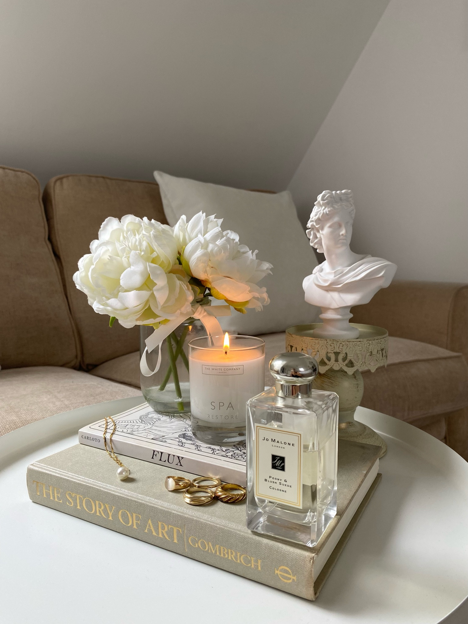 Styled my new coffee table in neutral tones ☕️🤎 Dopamine decor of:
- The White Company, Spa Restore candle
- Jo Malone London, Peony & Blush Suede perfume 
- Gombrich, The Story of Art
- Orion Carloto, Flux
- Etsy, Greek mythological sculpture bust 
- &otherstories and H&M, collection of gold rings and pearl necklace 
- White roses 

#LTKeurope #LTKFind #LTKstyletip