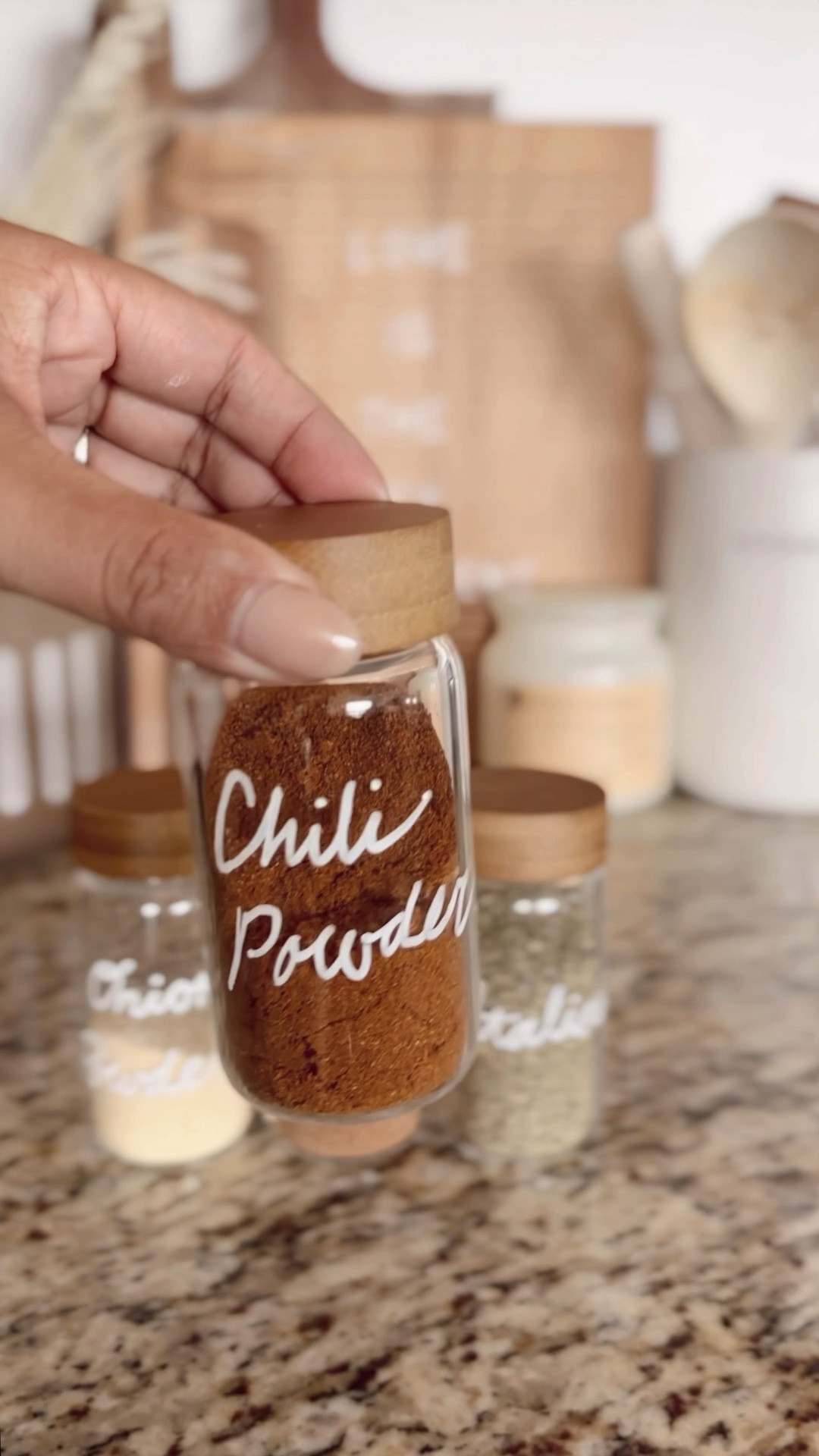 Pantry organization using items from The Container Store!  Marie Kondo spice jars - wooden spice rack - acacia wine rack - black baskets with wood handles - glass canisters with wood lids - home organization 

#LTKunder50 #LTKFind 

#LTKhome #LTKVideo #LTKfindsunder50