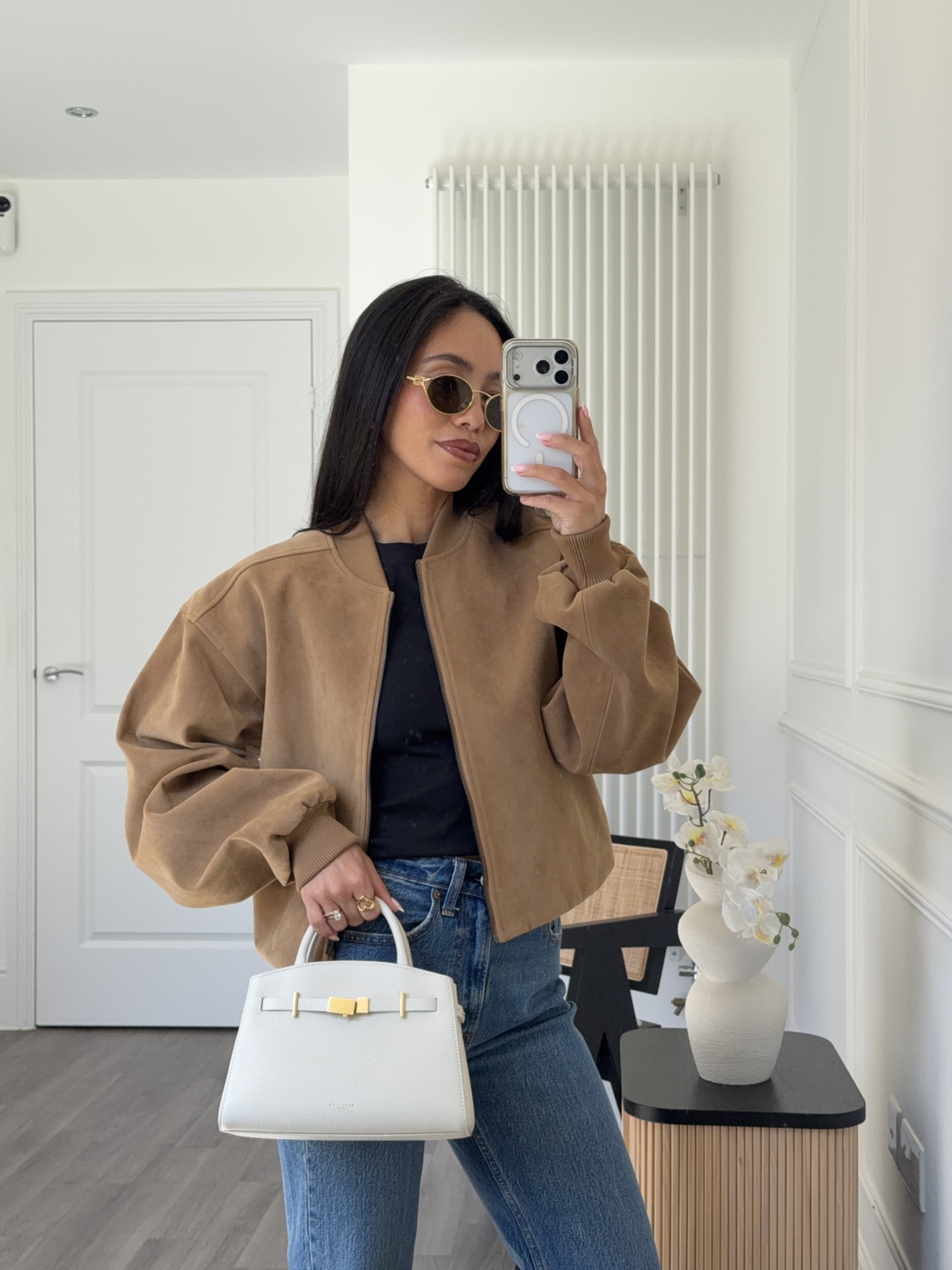 Sunny spring day OOTD 🤍 suede bomber jacket in tan with a classic tee and blue denim jean base. White accessories to brighten the outfit 

#LTKstyletip #LTKjeans #LTKspring