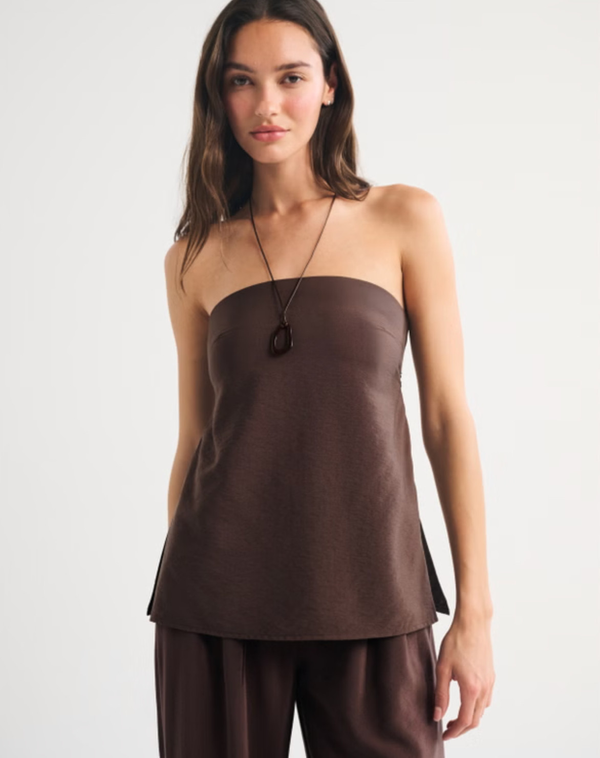 Effortless and a little elevated 🤍 The Abercrombie Strapless Open-Back Set Top is such a chic warm-weather piece. I love the textured crepe fabric, longer length, and the open-back tie detail — it’s equal parts easy and statement-making. Perfect styled with the matching set or your favorite bottoms for a put-together look ✨ 

 #LTKFestival #LTKgrwm #LTKootd