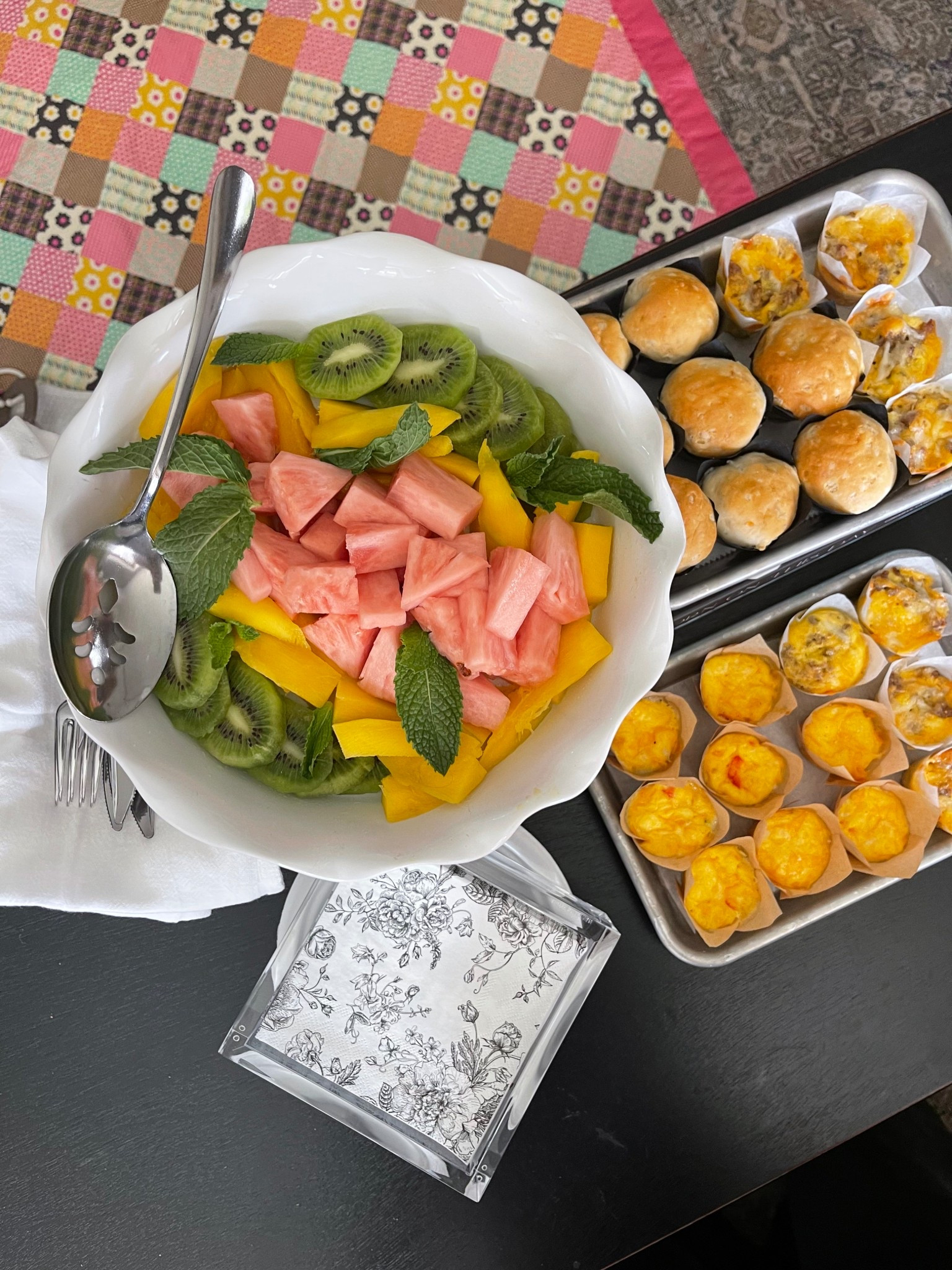Brunch spread!! Fruit served in a pie dish on a cake stand 🙌🏼 and small tin pans to serve mini muffins. Acrylic napkin holder always! 