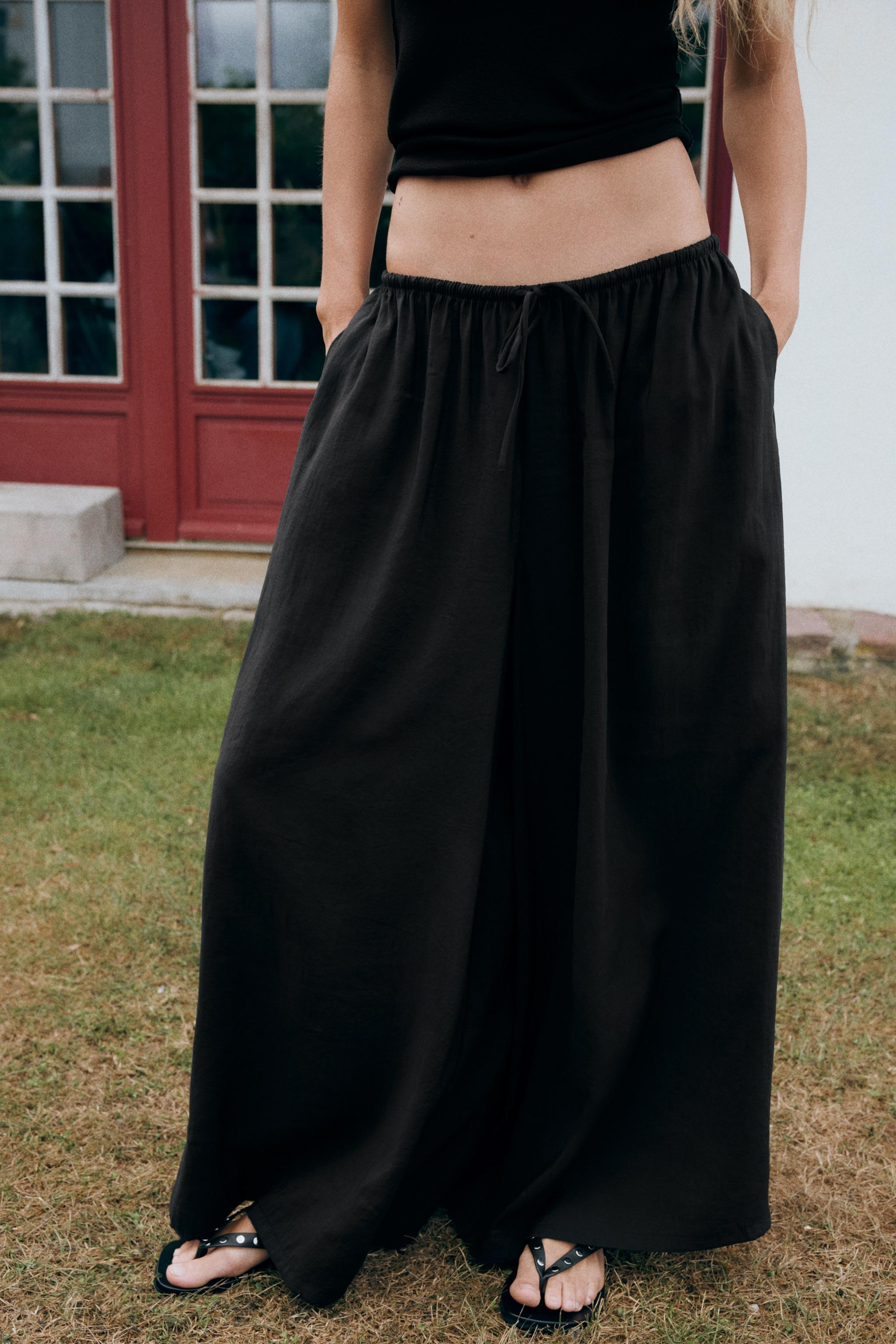 Pants made of flowy fabric. Mid-rise with adjustable drawstring waist. Hidden side in-seam pocket... | Zara US