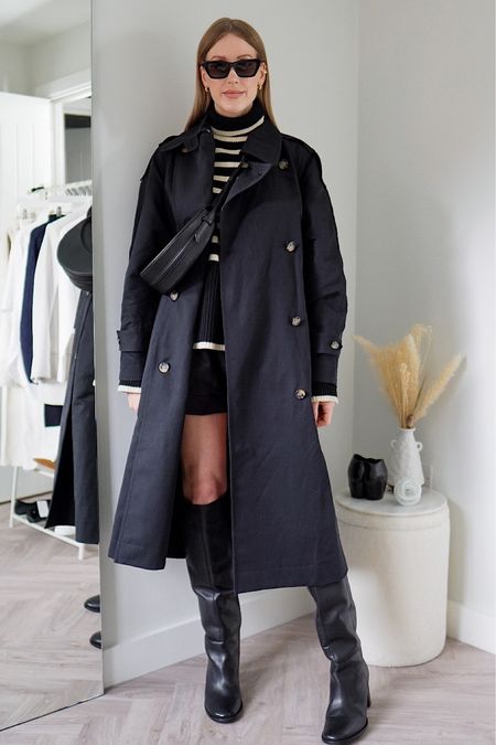 Black trench coat outfit styling striped knitwear with knee boots and leather shorts #trenchcoat #blackoutfit 

#LTKstyletip #LTKFind #LTKSeasonal