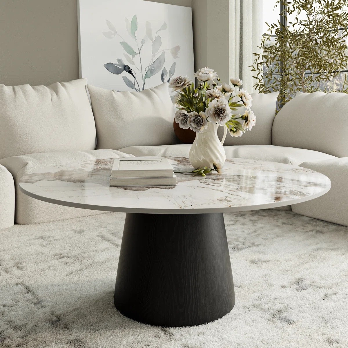 This round coffee table from Wayfair is the perfect statement piece for a modern living room. Featuring a stone top and a wooden pedestal base, it pairs beautifully with a neutral sofa, textured area rug, and minimal decor for a clean, elevated look. 