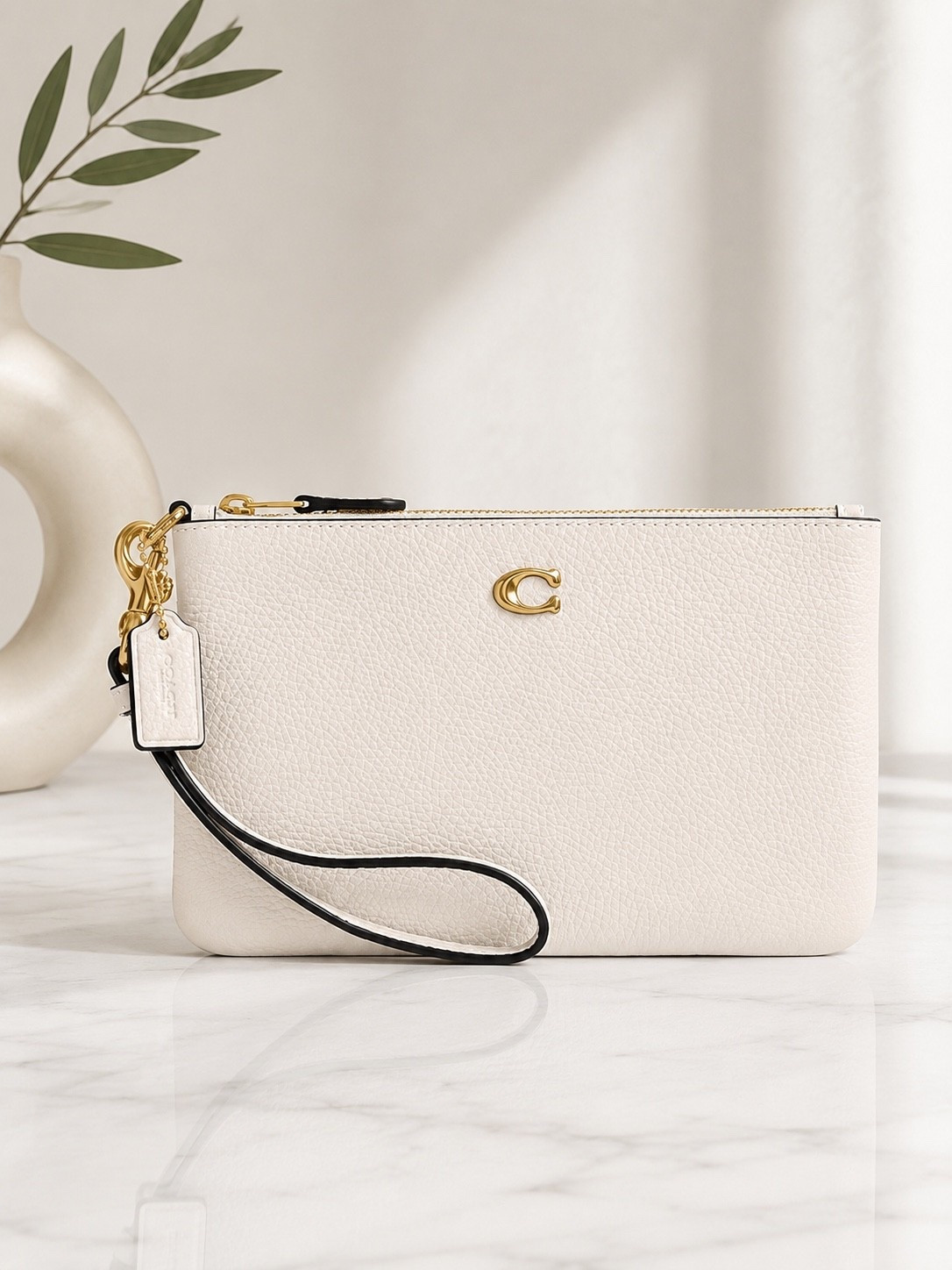 This wristlet is one of those timeless pieces you’ll use every day. The soft pebbled leather, gold hardware, and compact size make it perfect for running errands, date nights, or tossing into a larger tote. It holds the essentials without feeling bulky, and the neutral color goes with everything. Linked in my LTK!