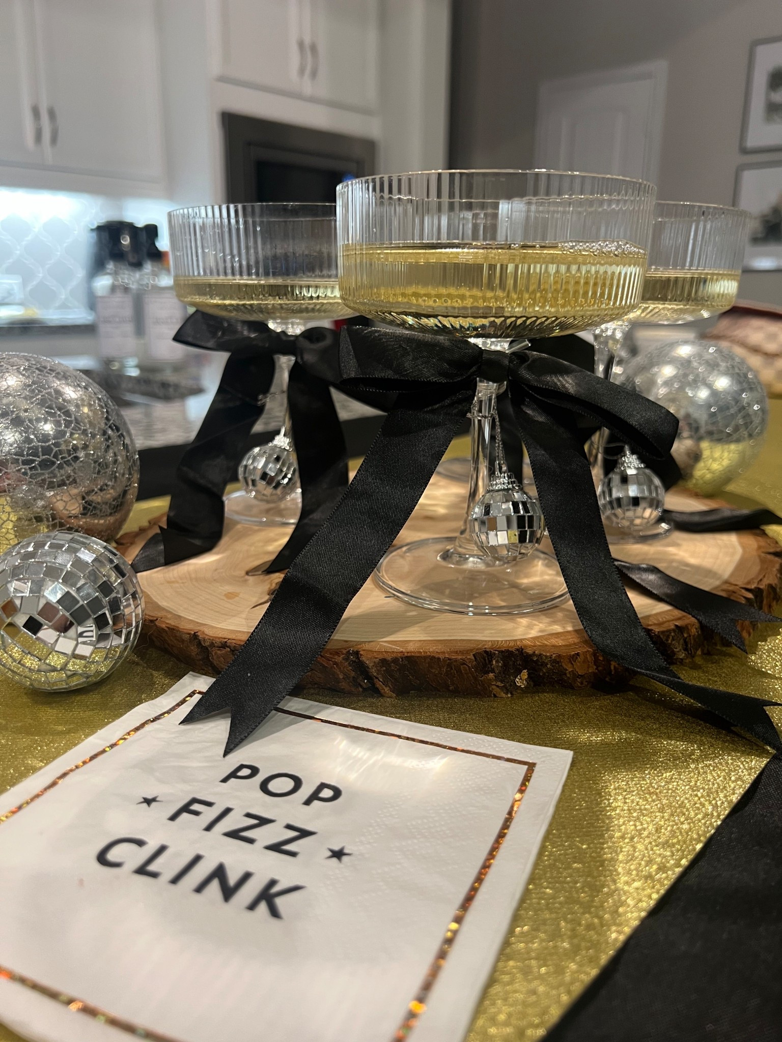 Bows 🎀 and Disco 🪩! 

Easy way to add a little fun to your New Year’s Eve Party or decor:

✨ add black bows to your glasses or bottles -adds a little pop of New Year’s and adds instant style!

🪩 mini disco ball ornaments are from @amazon but our local @dollartree still had plenty of disco balls left in two different sizes!

✨ Get a store bought cake and add disco balls and sparklers from @heb . This was our cake from last year and the kids loved the idea!

Thankful to be ringing in the new year in our cozies at home with family! We usually home cook the last meal of the year and enjoy a New Year’s Eve dinner together with the kids.

Because NYE doesn't have to be stressful to feel special. Good food, happy people, hearts of gratitude, and a new year to toast to. That's it. 🫶🏼🍾🥂 Happy (early) New Years Eve!

#LTKHome #LTKmomlife #LTKHoliday