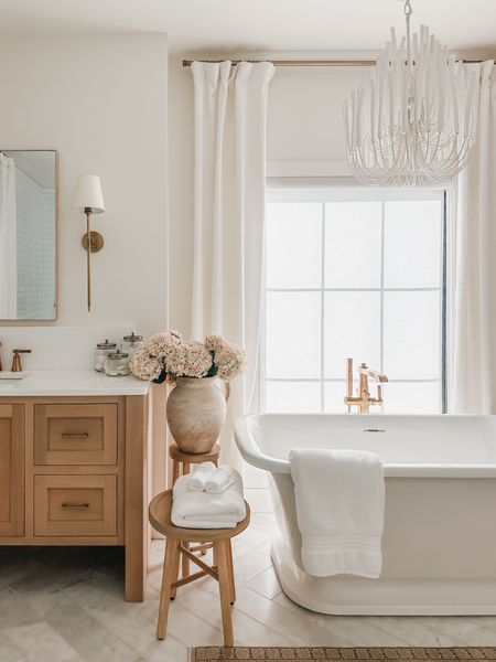 Light and bright primary bathroom with creamy whites, neutral wood tones, and pops of faux pink florals 

Bathroom refresh, light and bright, neutral style, vintage style rug, gold detail, wall sconce, faux florals, vase faves, woven basket, neutral wood tone, door knob detail, chandelier faves, tapered candle, curtain detail, gold hardware, shop the look!

#LTKStyleTip #LTKHome #LTKSeasonal