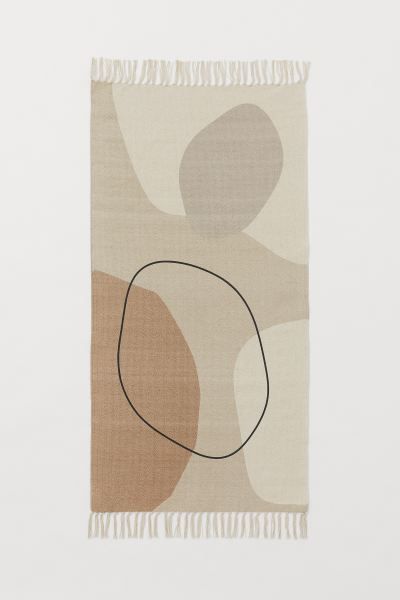 Conscious choice  Rug in woven cotton fabric with a pattern at front. Tassels at short sides.Weig... | H&M (US + CA)