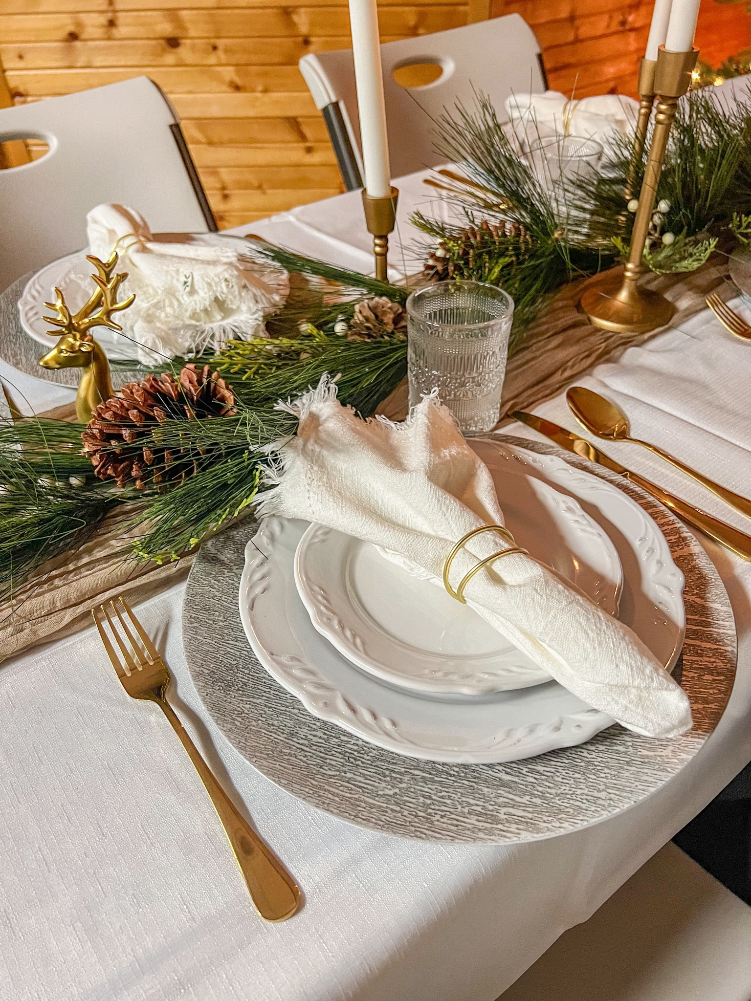Easy affordable Christmas table setting with gold silverware and greenery 

Christmas dinnerware, Christmas garland, candle stick holders, gold reindeer, Christmas decor 

#LTKSeasonal #LTKHoliday #LTKparties